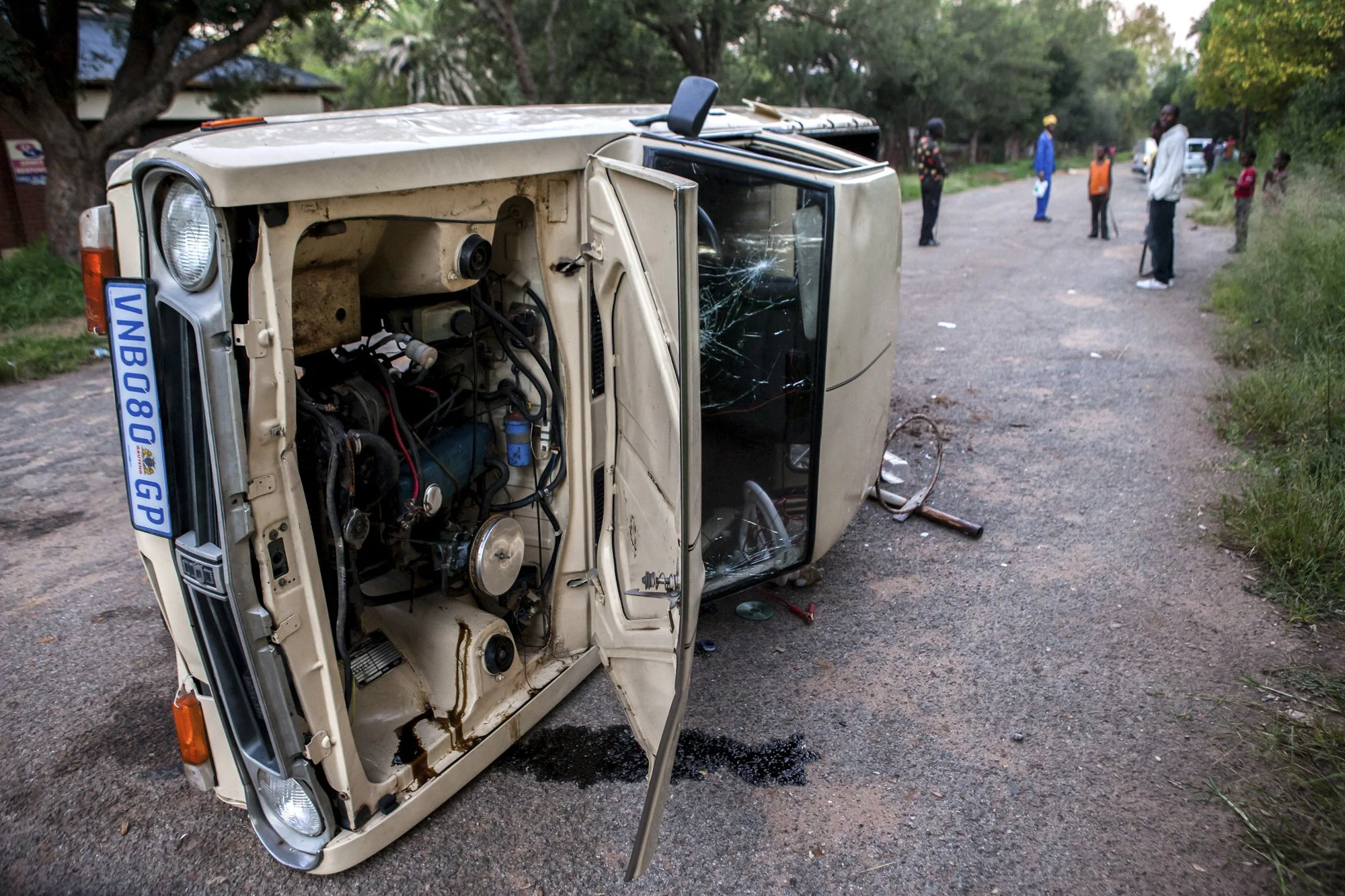 A truck used by copper-cable thieves lies overturned on a road in Durban Deep, on the outskirts of Johannesburg, after local residents—exasperated by repeated attacks on their neighborhood and a lack of police response—formed a vigilante group to con