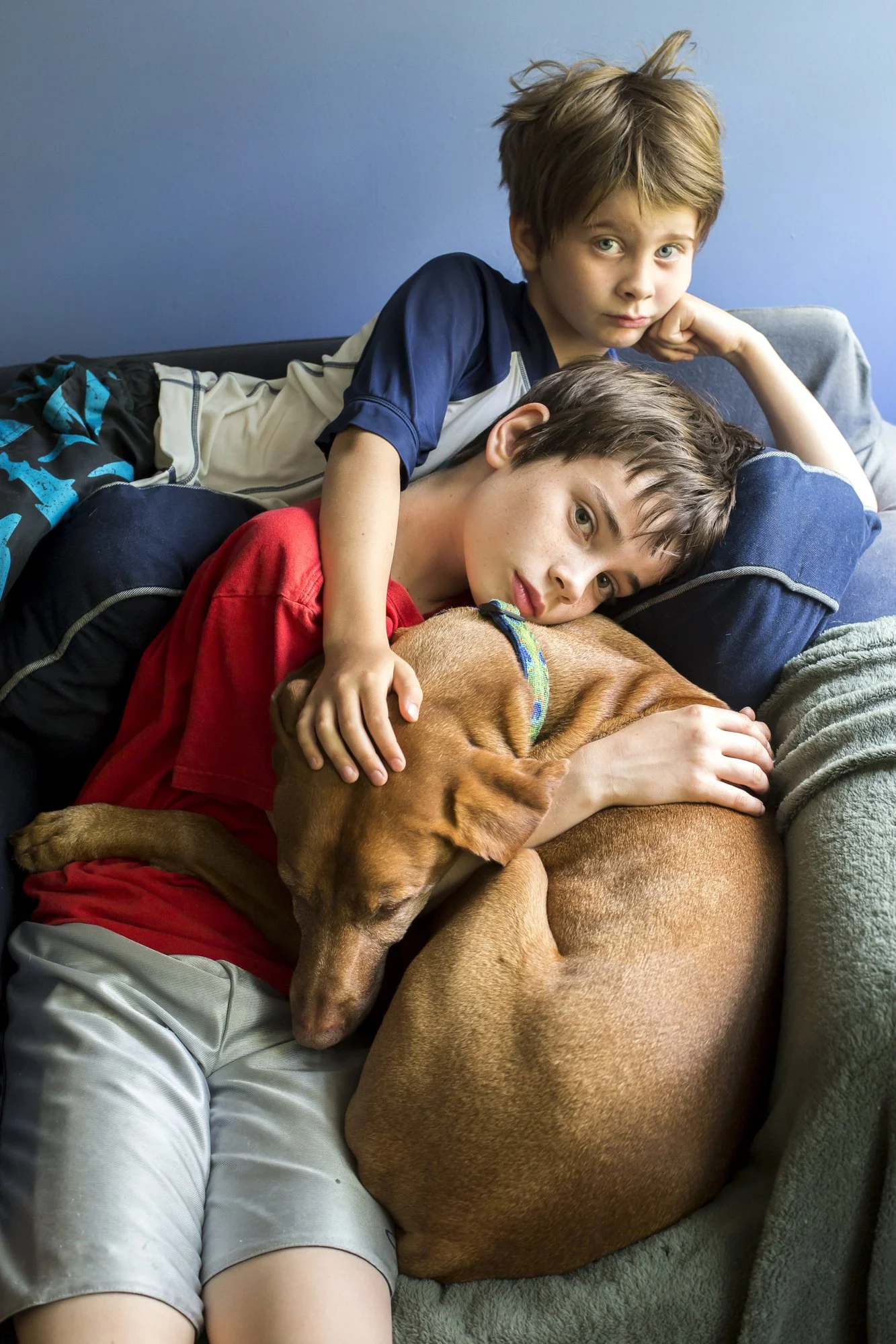 My nephews snuggle with their cousin, Winnie the Pooch, on their last morning before heading home. After a week together, the goodbye comes with quiet sadness and a final moment of closeness.