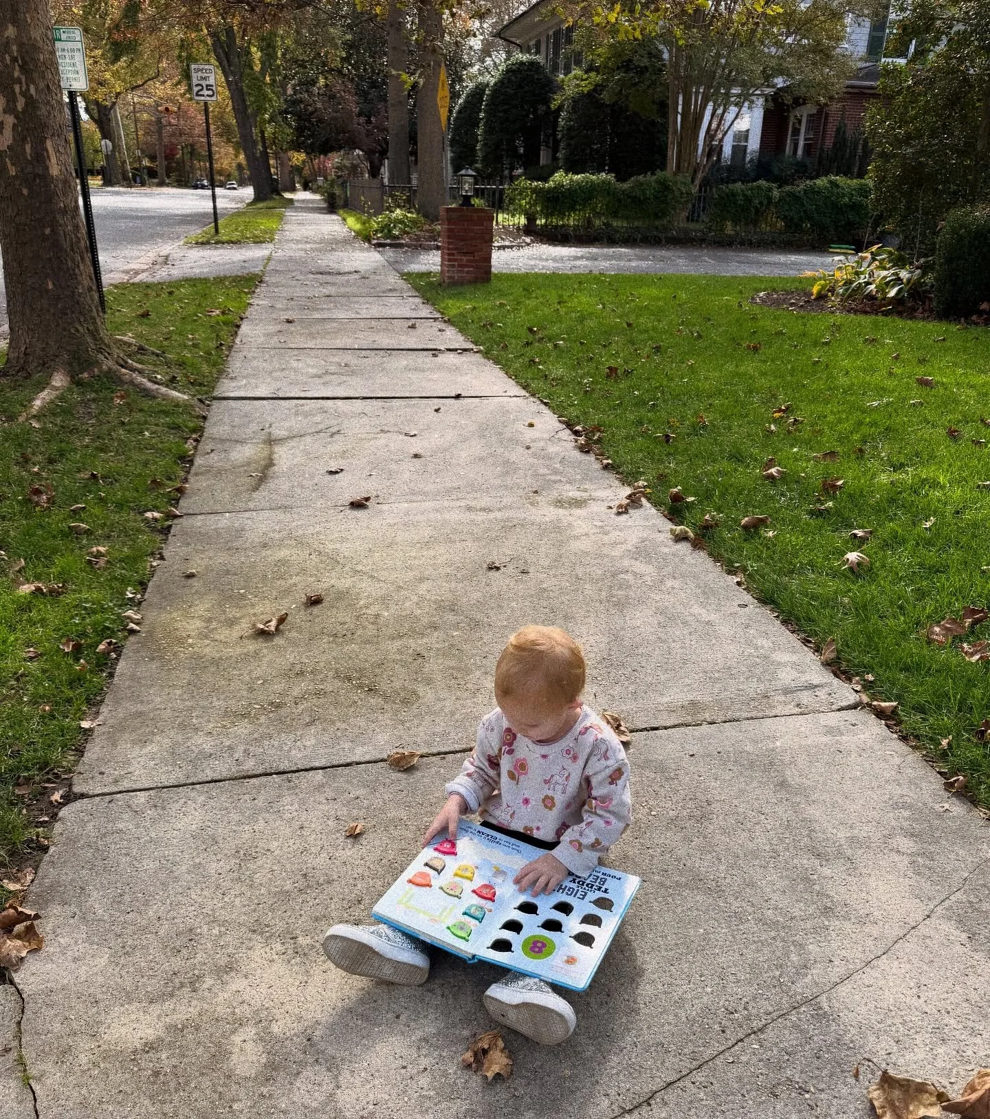 She dropped straight to the sidewalk today halfway back to the car, opened a book she grabbed from the Little Free Library, and started reading like the world could wait.

My first instinct? Absolutely not. Get up. People will think we&rsquo;re weird