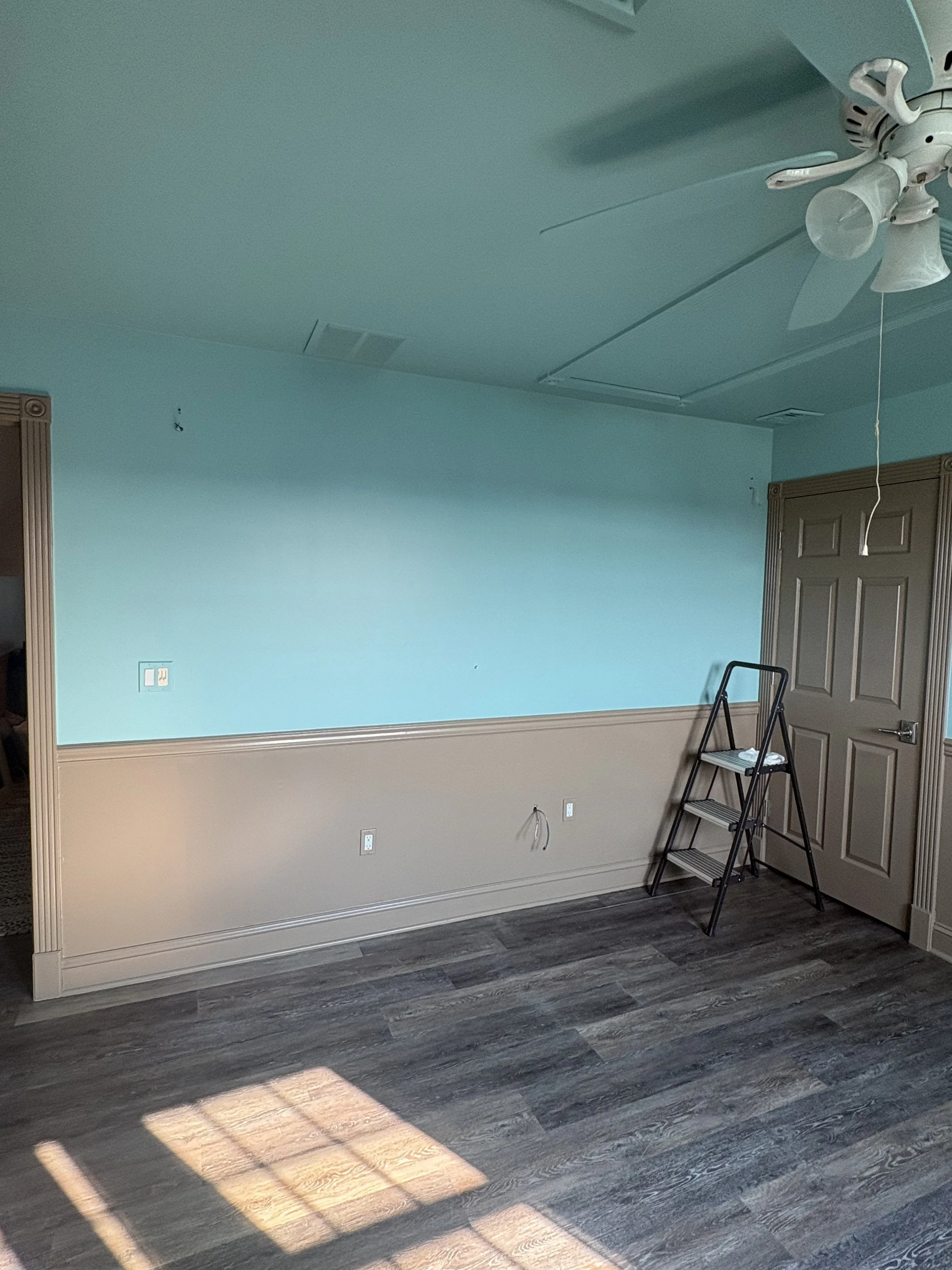 A bold and creative painting project for a homeowner with amazing taste. She chose to step outside the box with **taupe and aqua blue trim**, creating a unique and beautiful look. Once she added her decor, the space became even more incredible. Proof