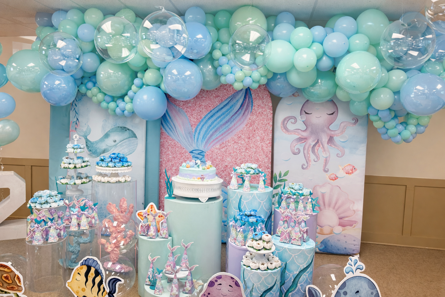 Pastel under-the-sea themed balloon backdrop with mermaid-inspired colors and details.