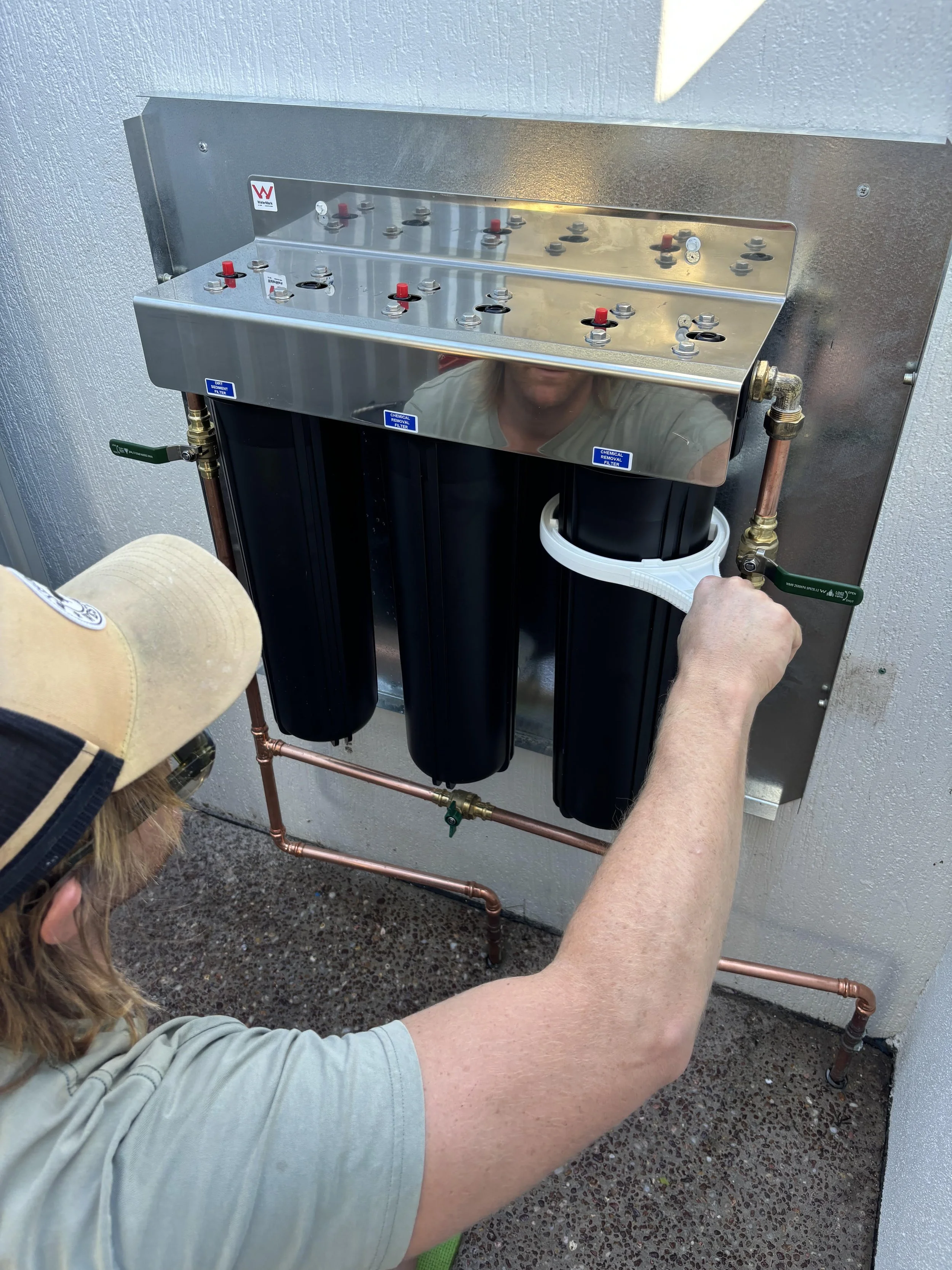 Licensed plumber installing whole home water filtration system gold coast