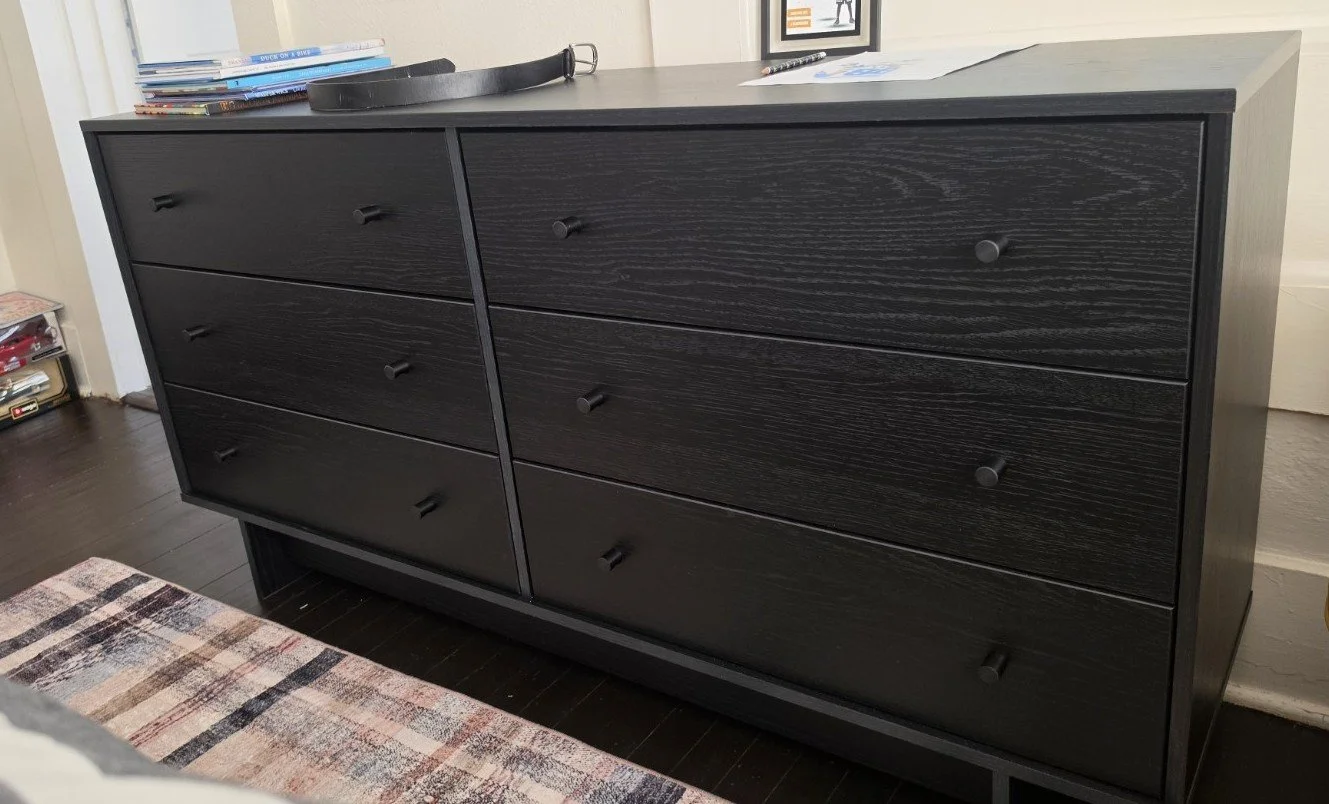 Black six-drawer dresser selected for the boy’s bedroom refresh
