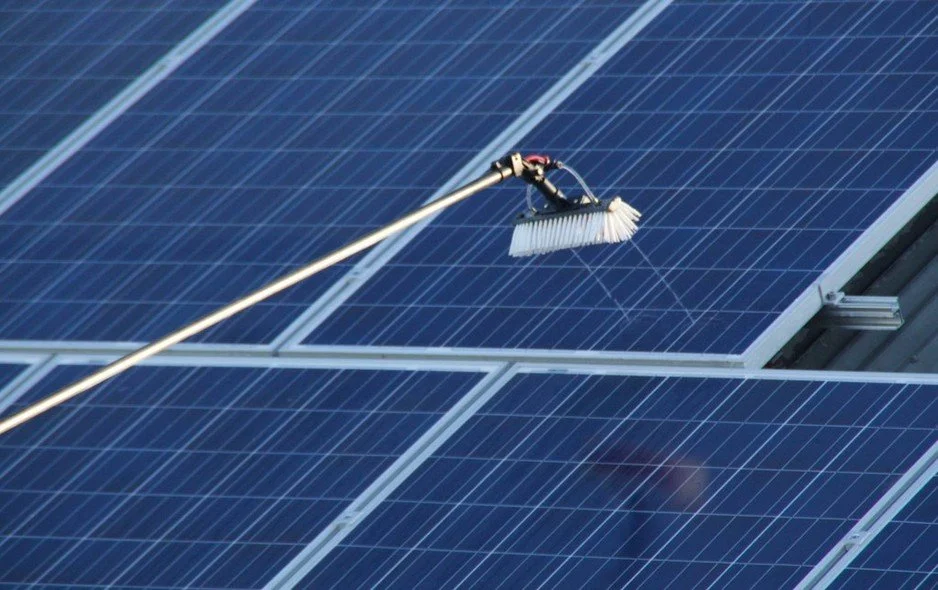 Solar panels on the roof of a brick house, looking very clean.