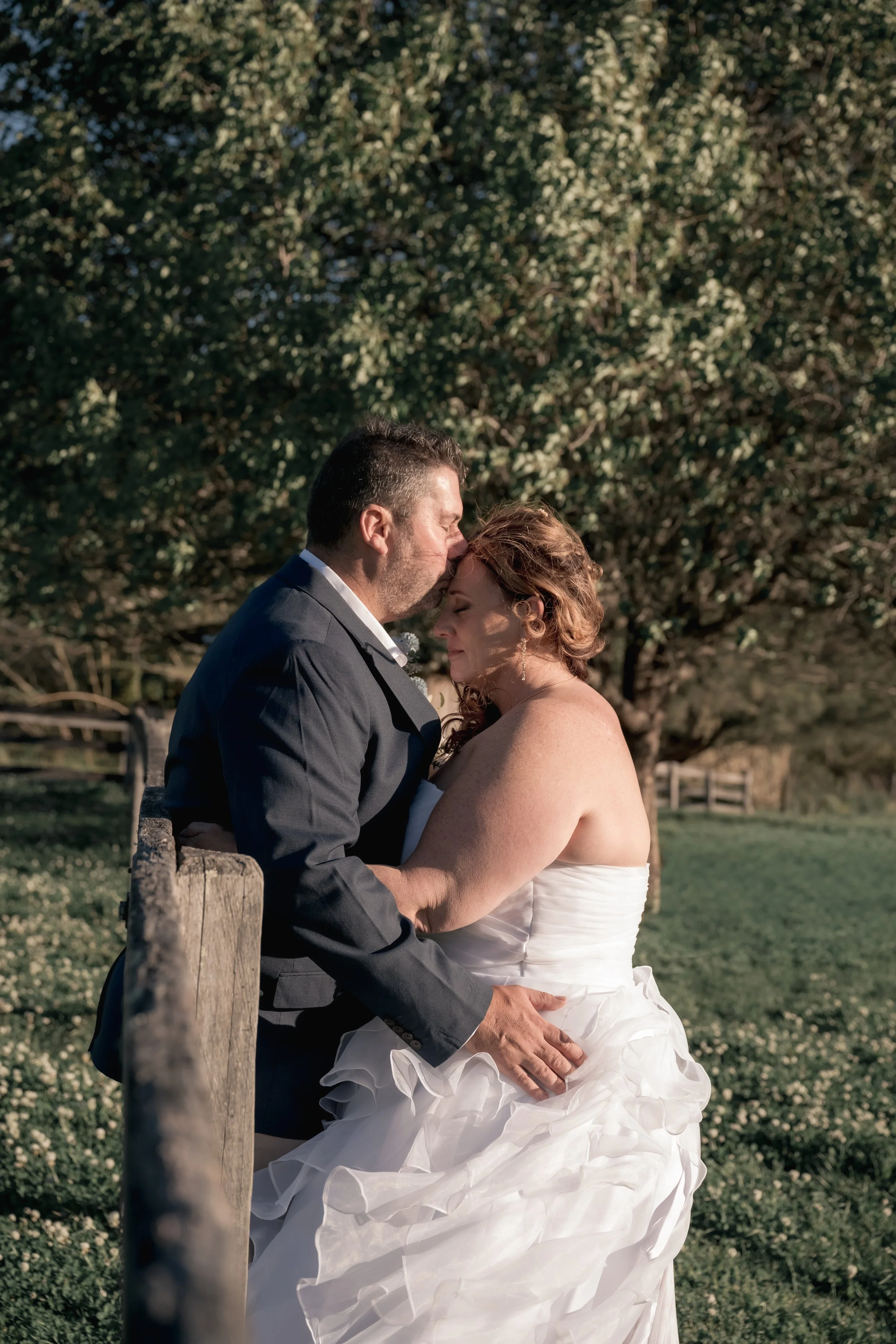 Em Whalan photographing a joyful wedding couple surrounded by greenery — authentic, relaxed Hunter Valley wedding photography.