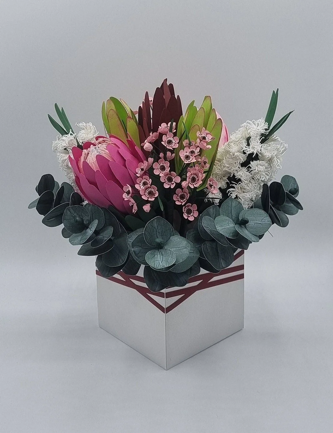 Handcrafted paper bouquet featuring Proteas, eucalyptus, bottle brush and wax flowers — a lasting Australian native-inspired floral gift for any occasion.
