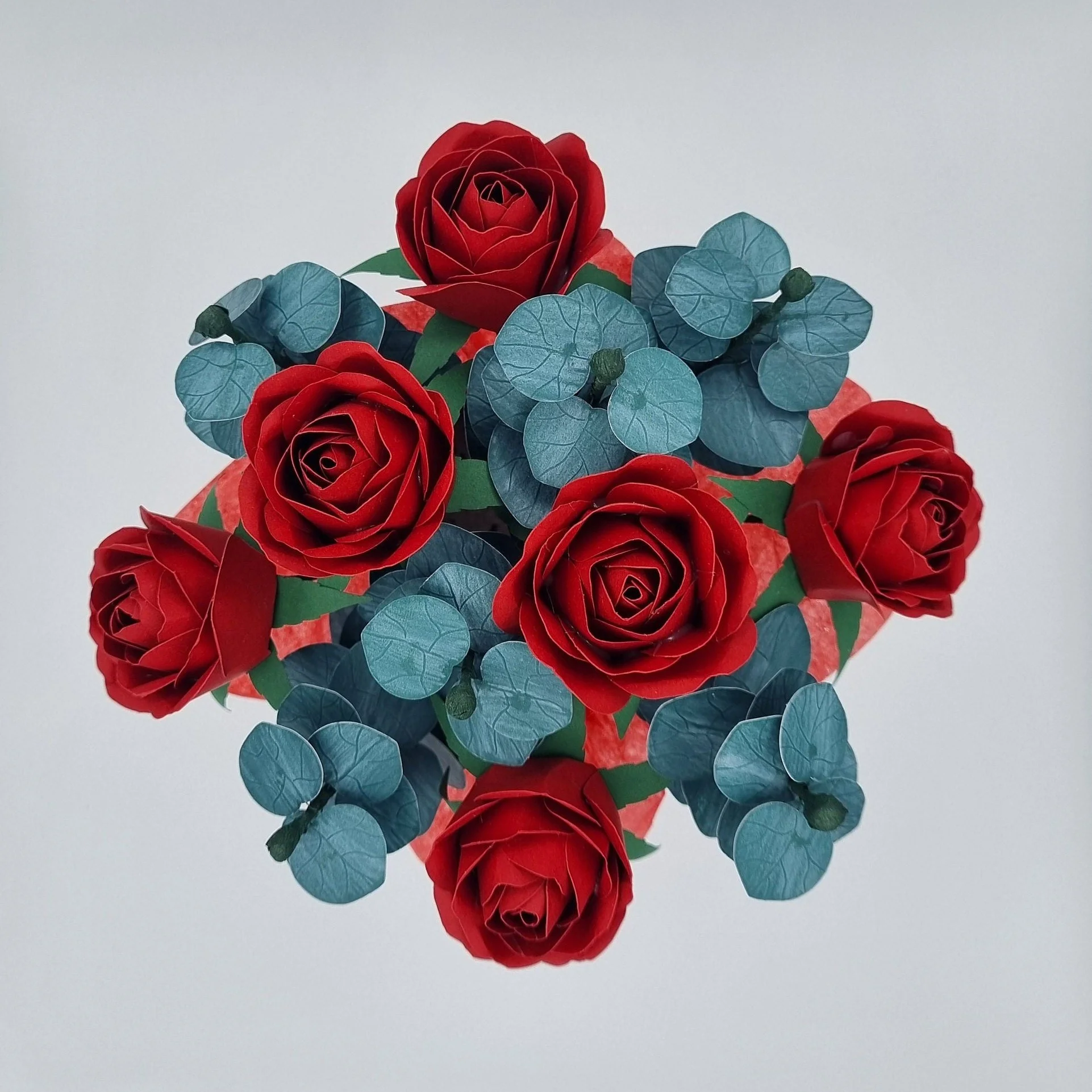 Paper flower bouquet, featuring red roses and eucalyptus