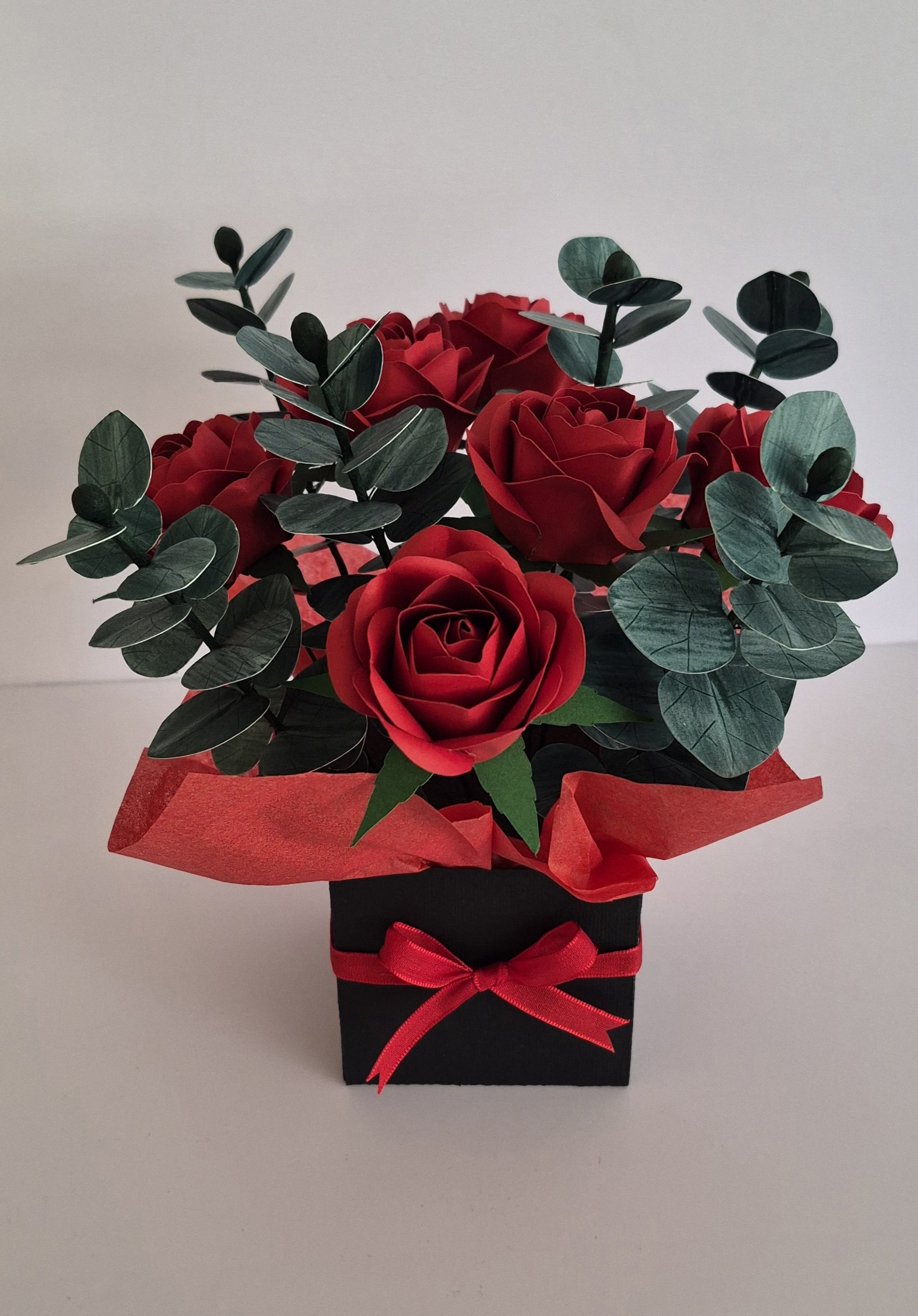 Handmade red paper rose arrangement in black gift box with eucalyptus