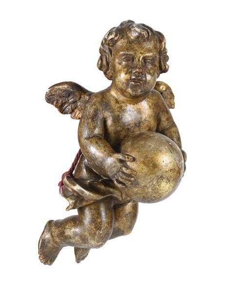 A gold cherub holding a sphere or globe in both hands