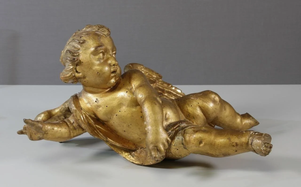 Eighteenth-century gold cherub in a supine posture