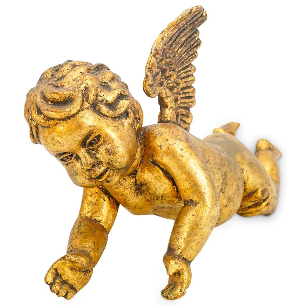 A gilded cherub with a menacing face