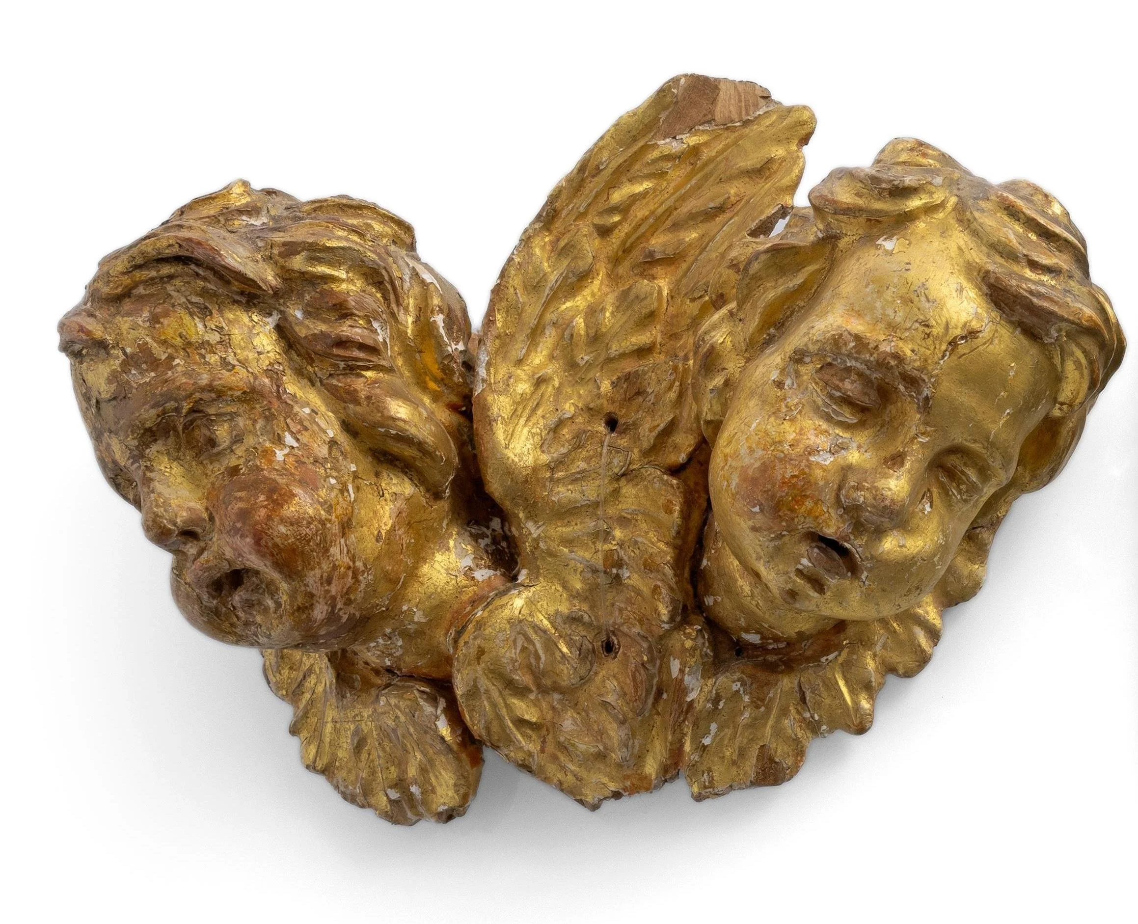 A pair of gilded grotesque winged cherub heads
