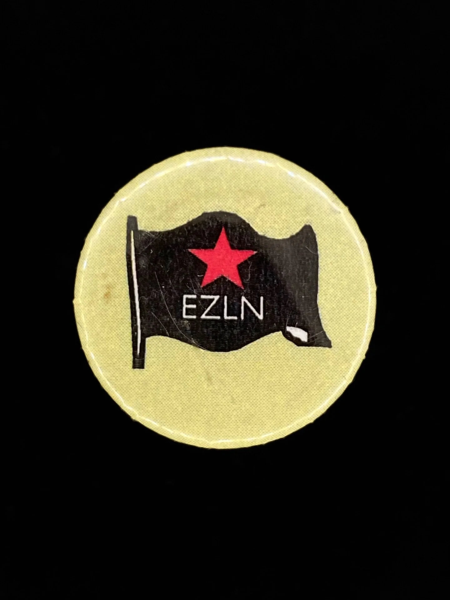 "EZLN" Button, made by supporters in the United States, 1990s.

The Ej&eacute;rcito Zapatista de Liberaci&oacute;n Nacional (EZLN), or Zapatistas, initiated an armed insurrection in Chiapas, Mexico in the first week of January, 1994. Timed 