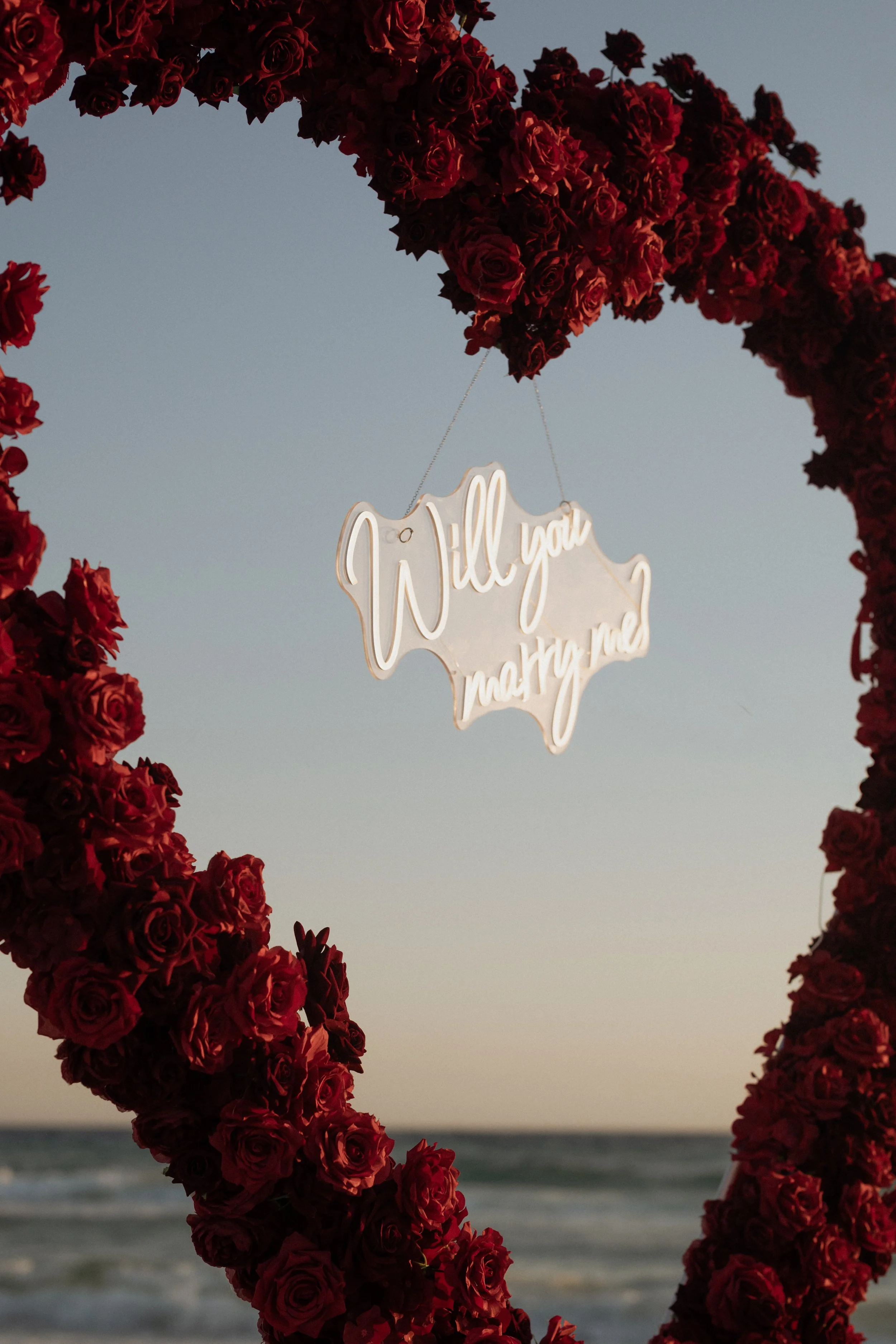 Panama City Beach Proposal with deep rose set up from coastal bloom, photos by Panama City beach photographers team