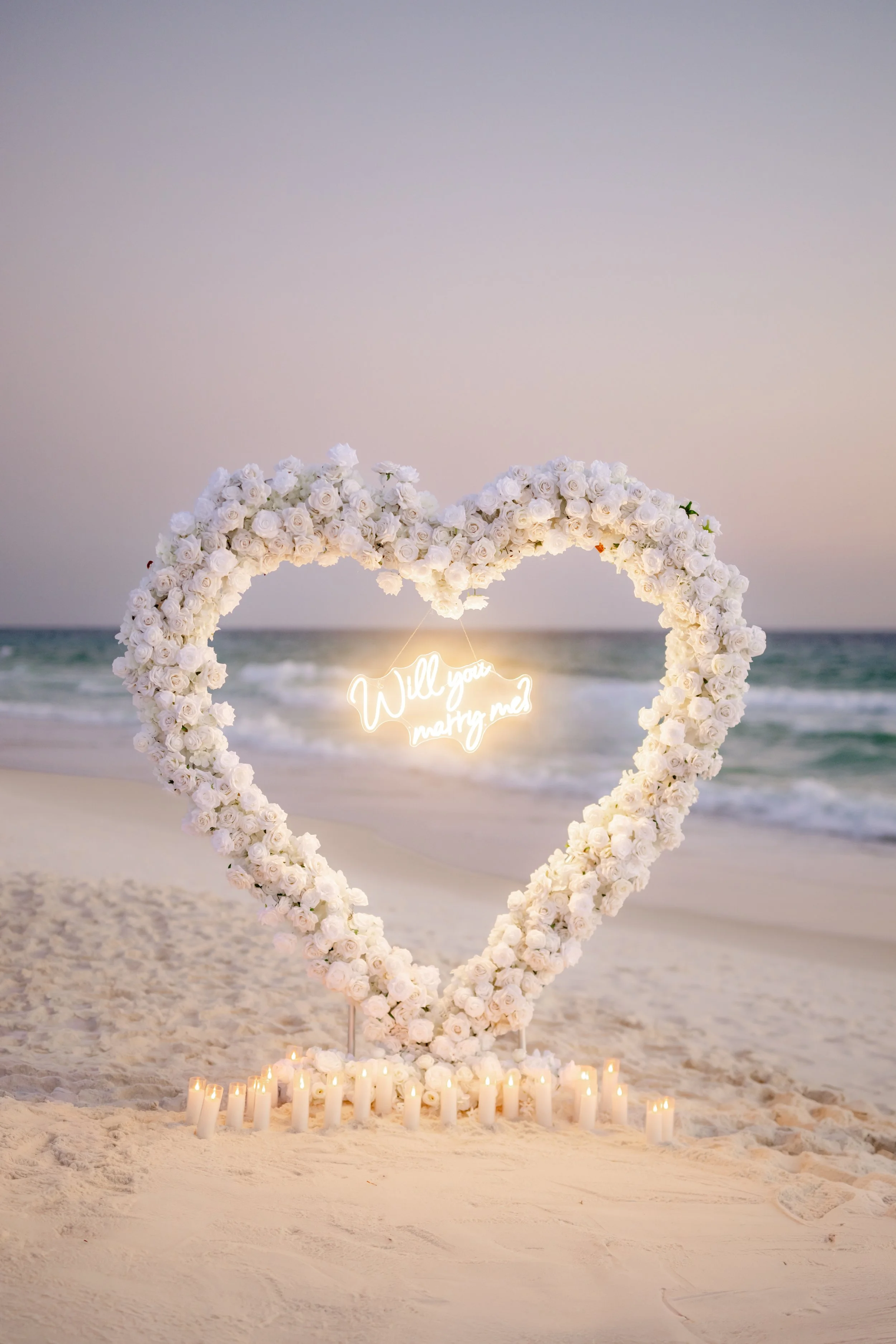 Panama City Beach Proposal with white rose set up from coastal bloom, photos by Panama City beach photographers team