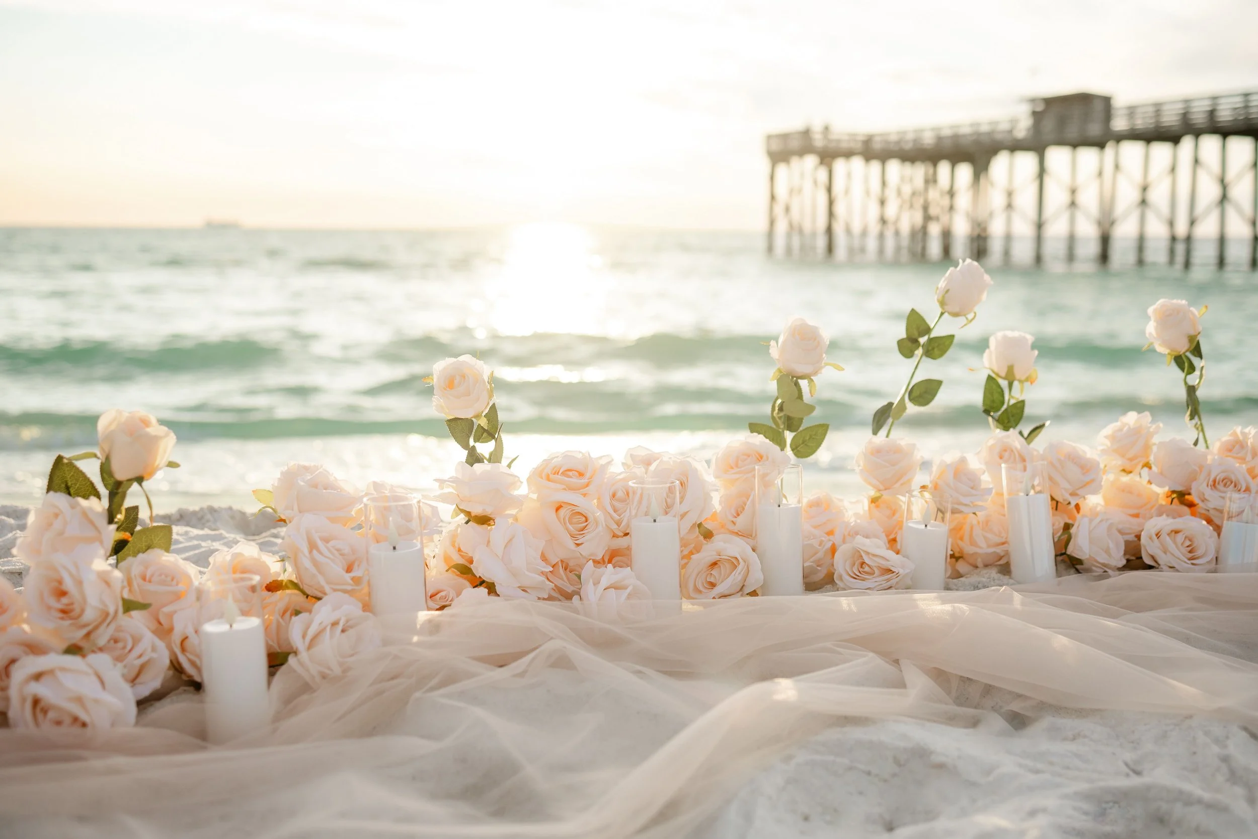 roses and candles on the beach at sunset at st andrews state park beach in Panama City beach florida