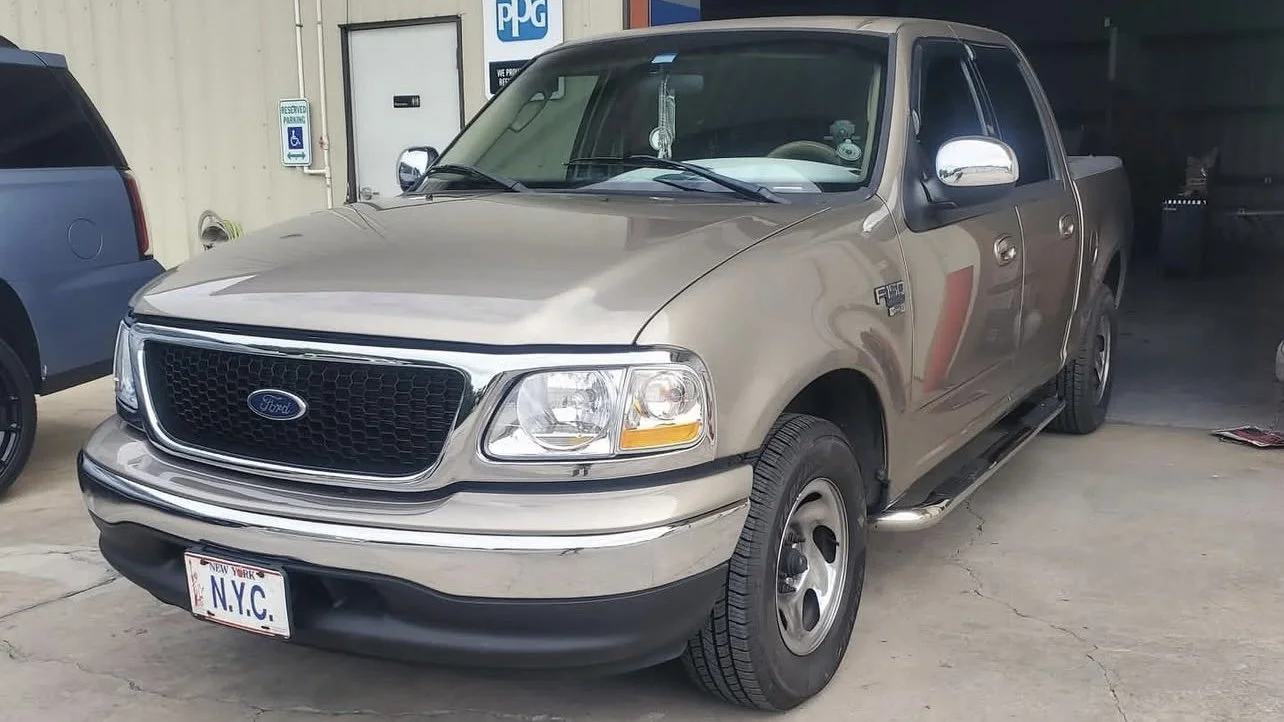 Ford truck parked in front of garage