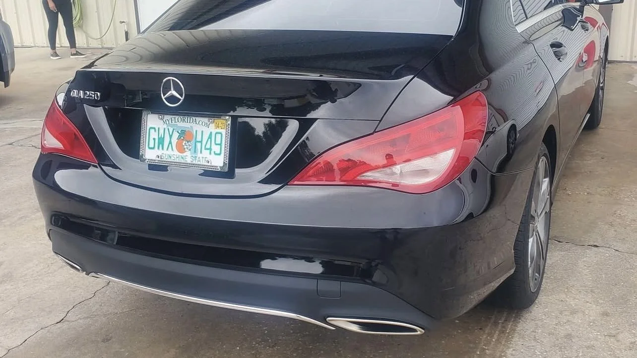 Rear view of a black Mercedes-Benz CLA 250 with Florida license plate.
