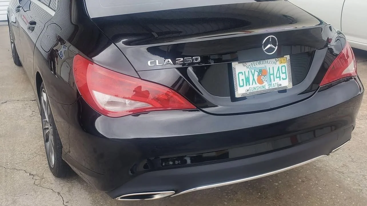 Rear view of a black Mercedes-Benz CLA 250 with a Florida license plate.