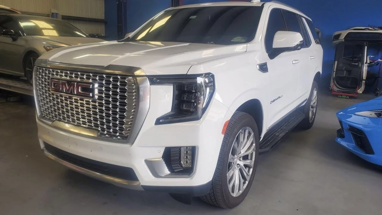 White GMC SUV parked in a garage