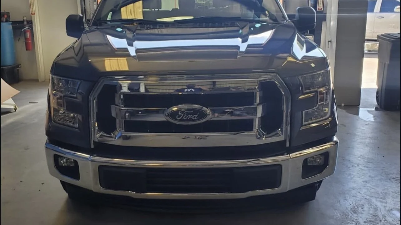Front view of a Ford pickup truck in a garage.