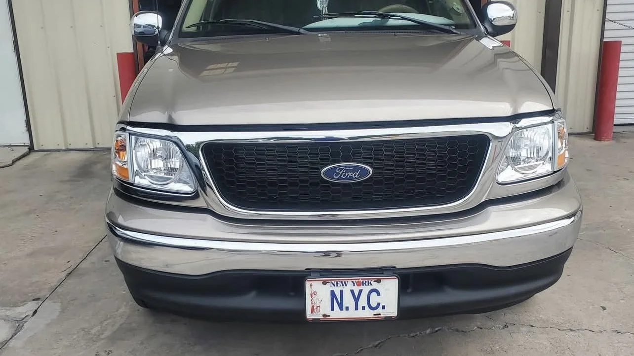 Front of silver Ford truck with New York license plate labeled 'N.Y.C'.