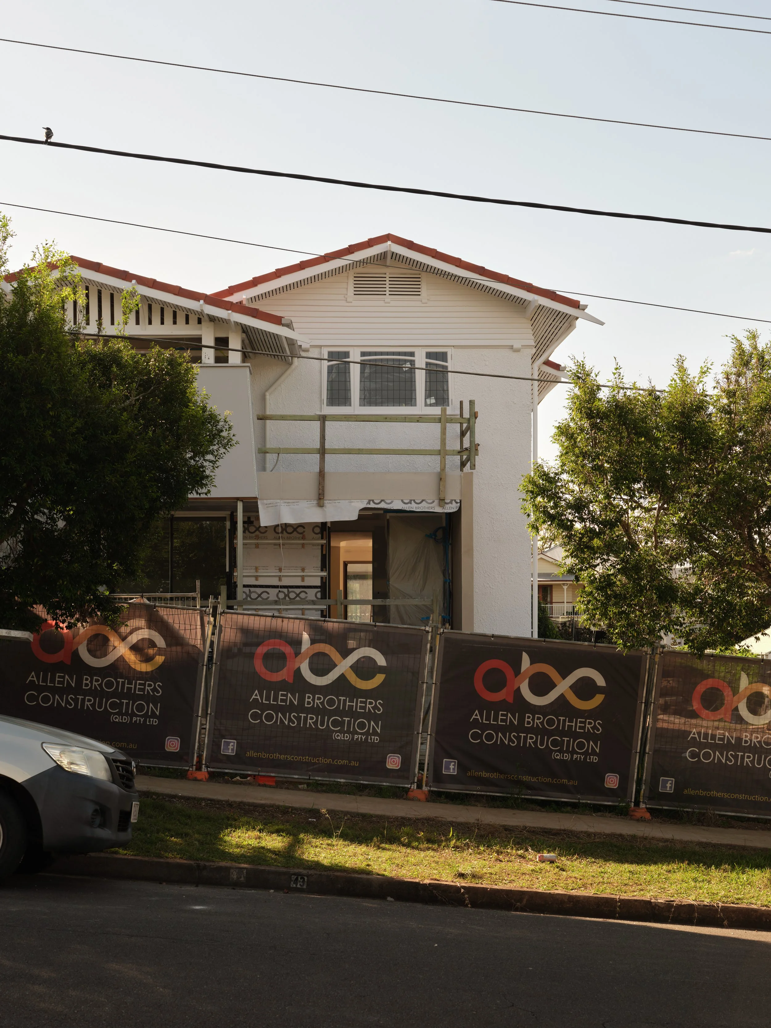 This image captures a large‑scale residential renovation underway by Allen Brothers Construction. The existing two‑storey home is surrounded by scaffolding as structural and architectural upgrades progress, showcasing the complexity of the project. T