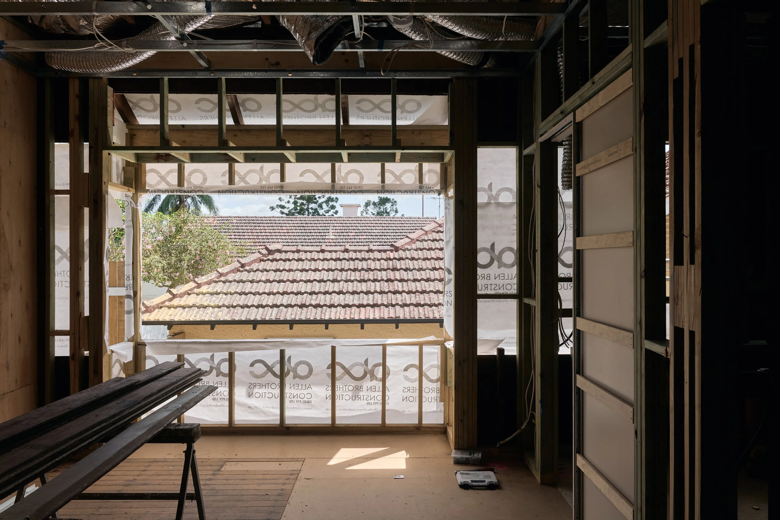 This image shows the interior of a major renovation project managed by Allen Brothers Construction, highlighting the scale and complexity of the structural work involved. The home is fully stripped back to framing, with new timber structure, ductwork