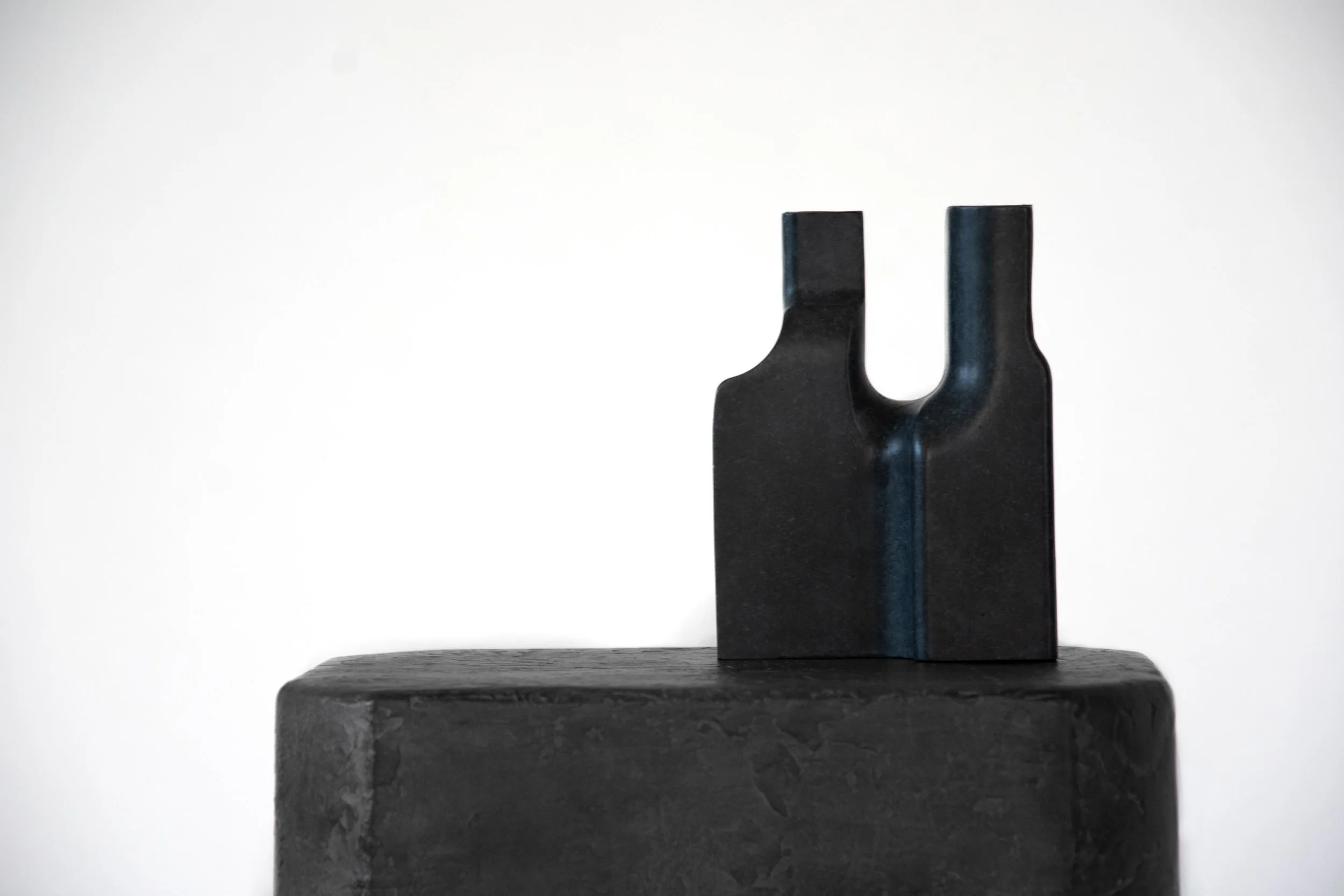 Grey bronze vase set against a plain white background