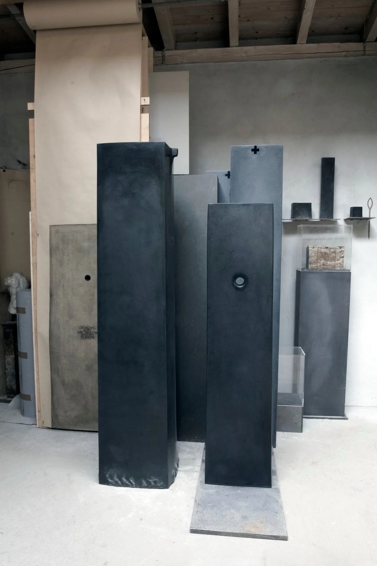 Various black and gray rectangular and square slabs in a workshop.
