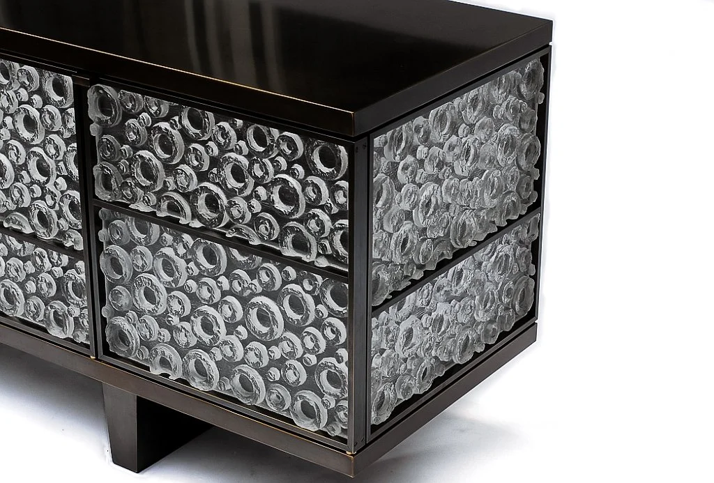 Modern black sideboard with drawers filled with handcrafted glas