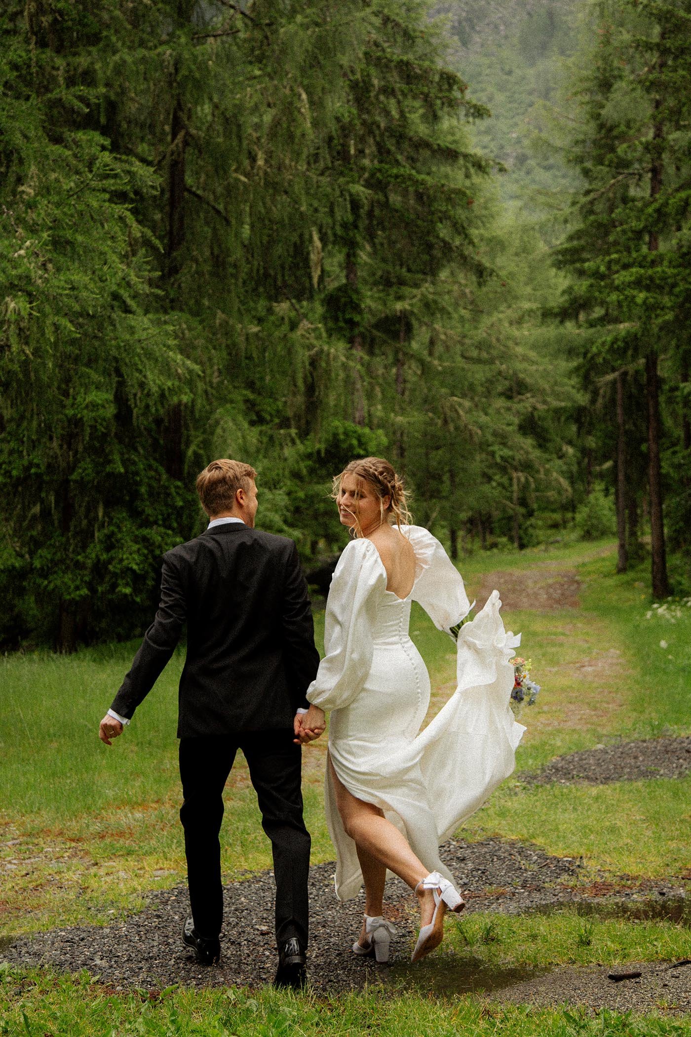 chamonix-alpine-wedding-couple-walking-forest.jpg