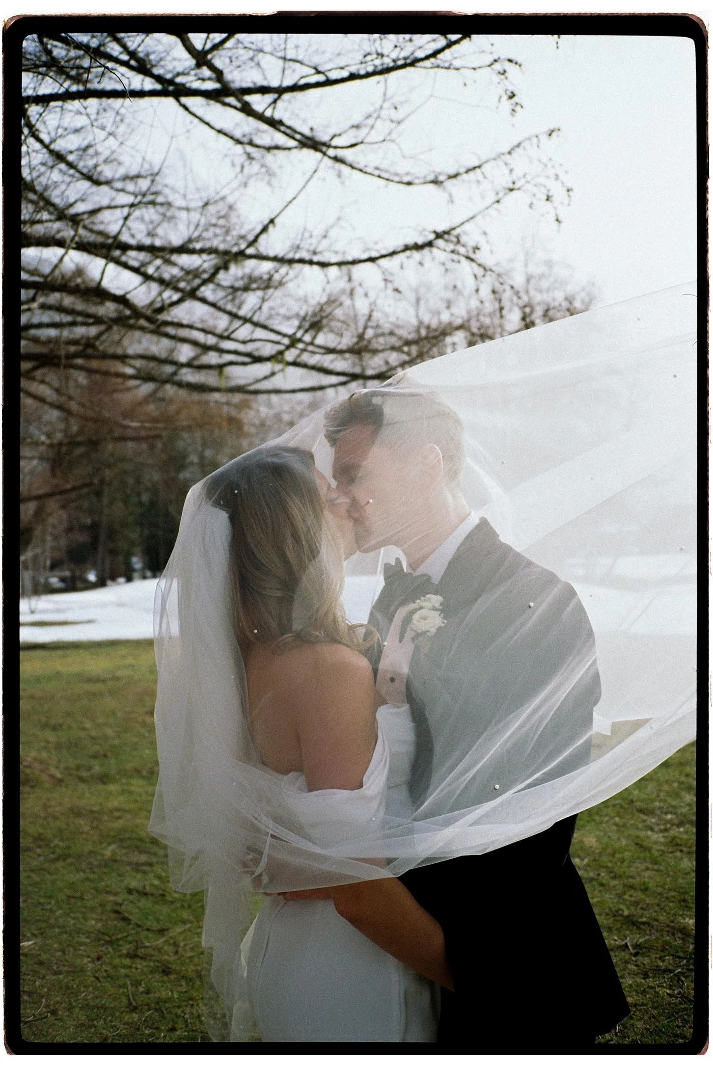 tori-harry-chamonix-wedding-veiled-kiss-portrait.jpg