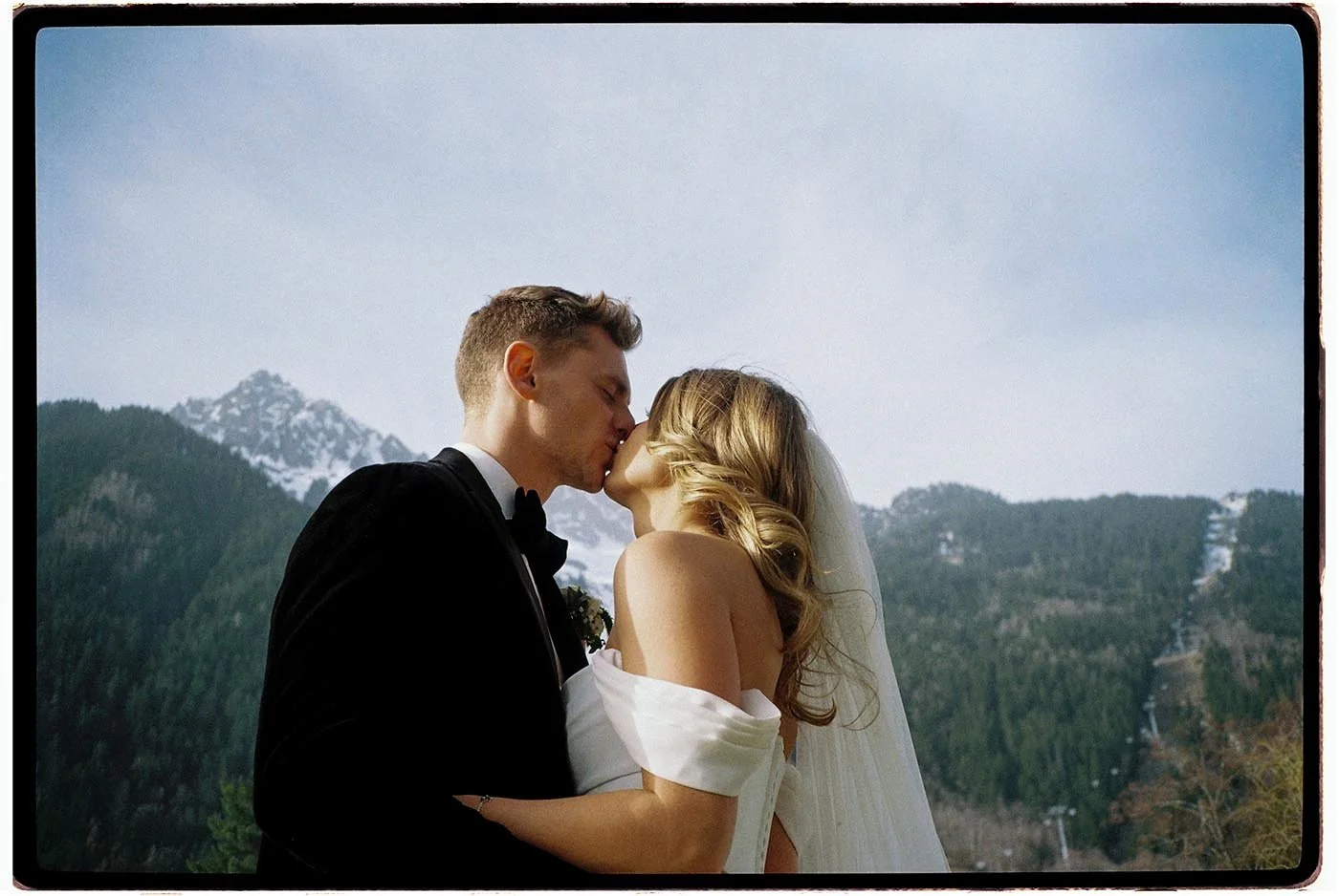 tori-harry-chamonix-wedding-couple-kiss-mountain-backdrop.jpg
