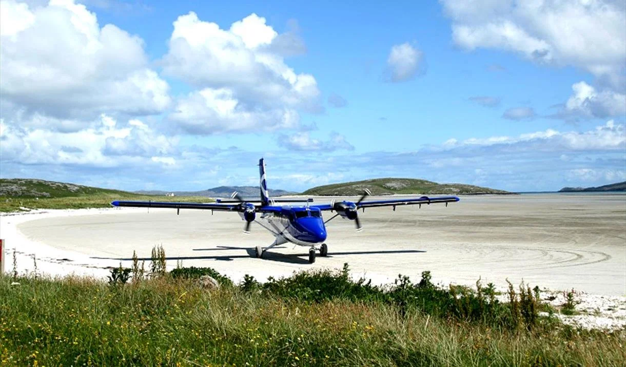 plane taxiing at barra airport in scotland