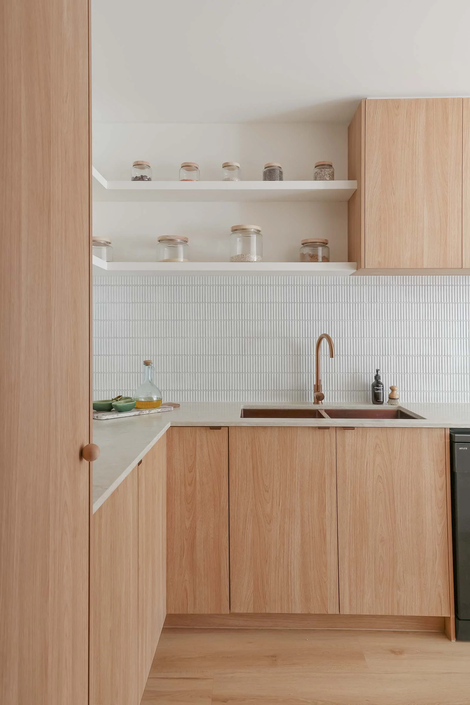 neutral kitchen wood cabinetry coastal interior brushed copper tapware