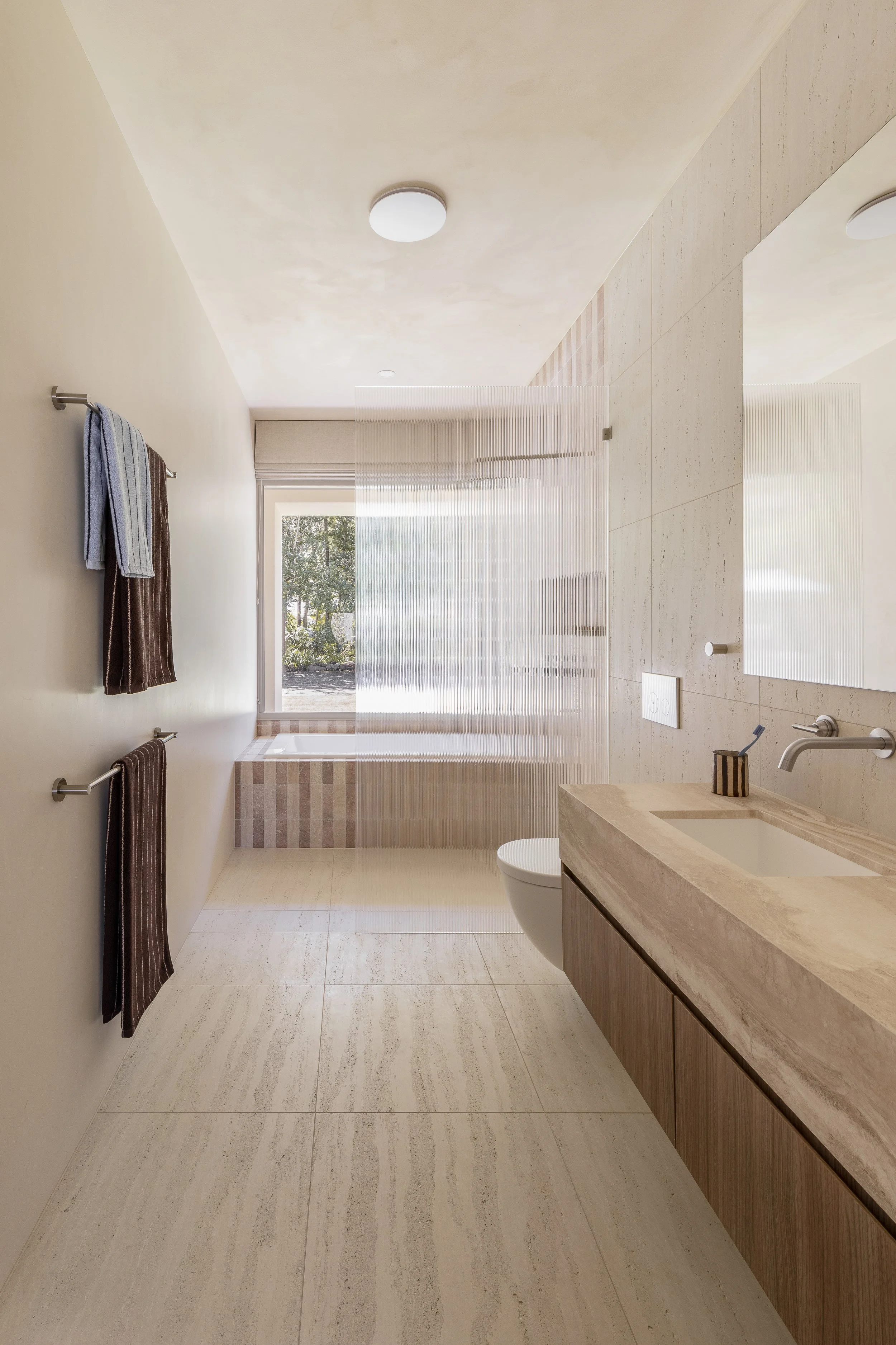 the valle casa neutral travertine bathroom