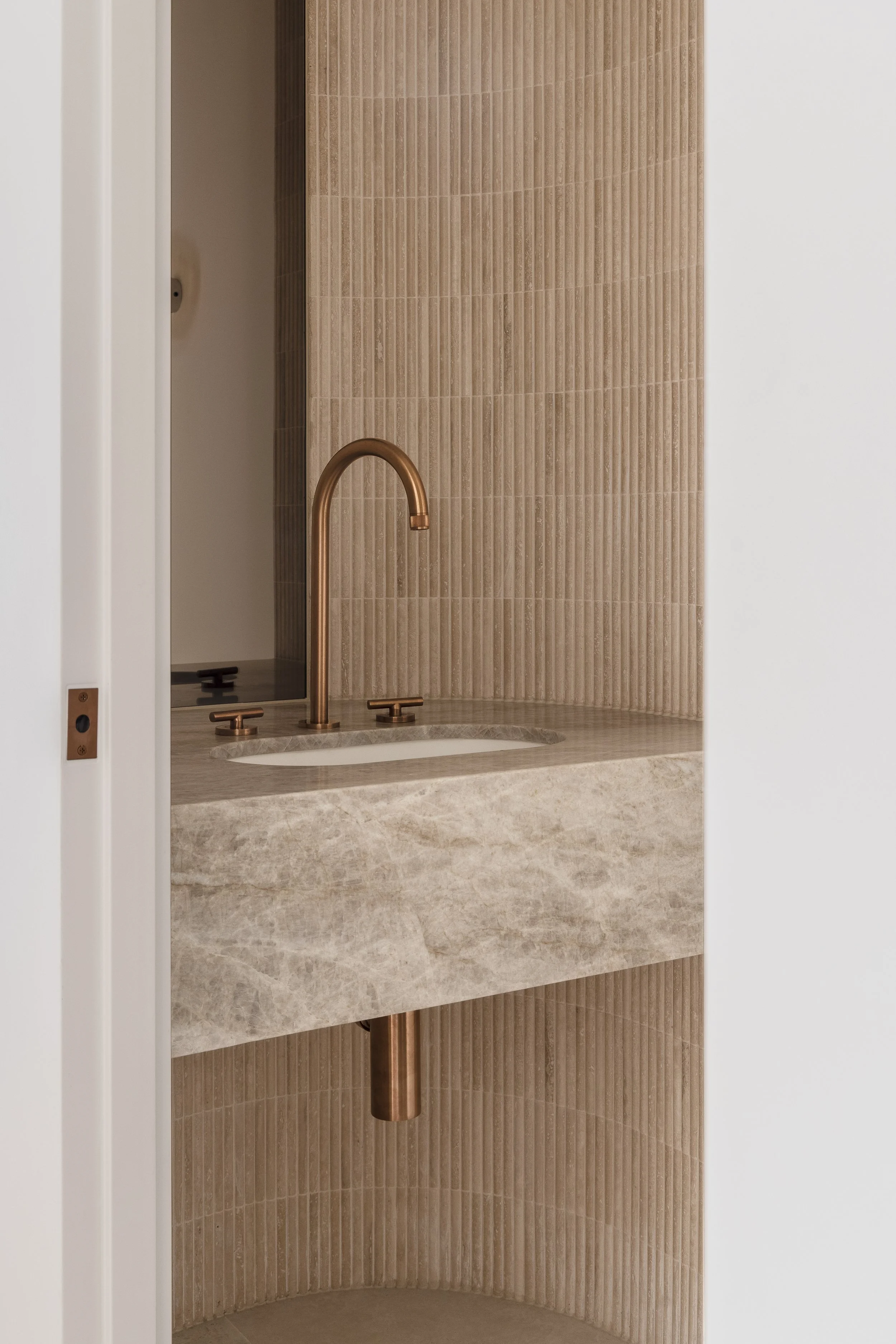 warm-moody-powder-room-brushed-copper-tapware-floating-marble-vanity