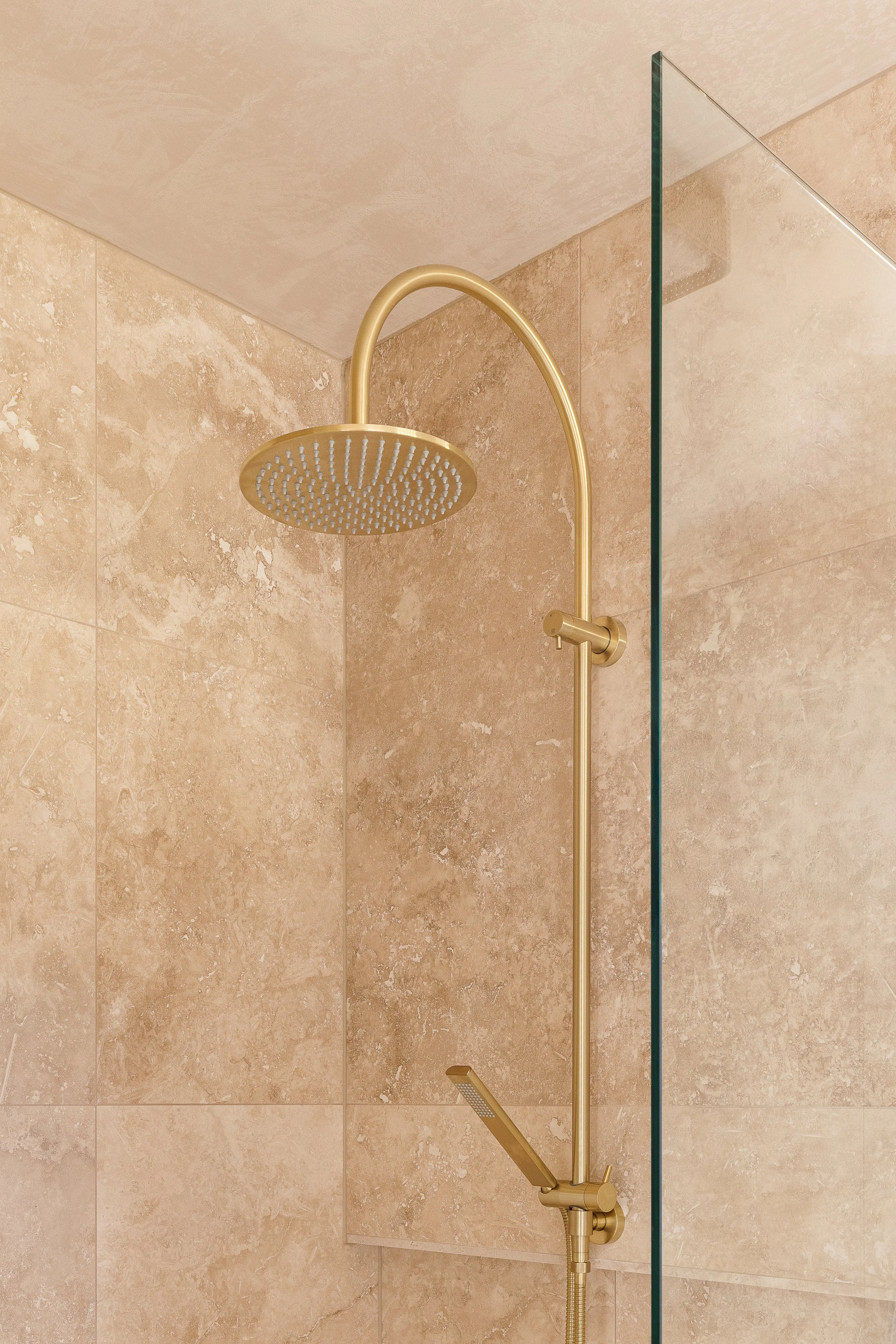 Brushed-Brass-shower-tapware-travertine-tiles