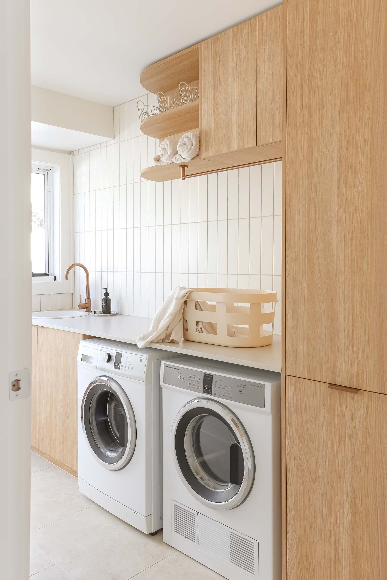 coastal neutral wood cabinetry laundry
