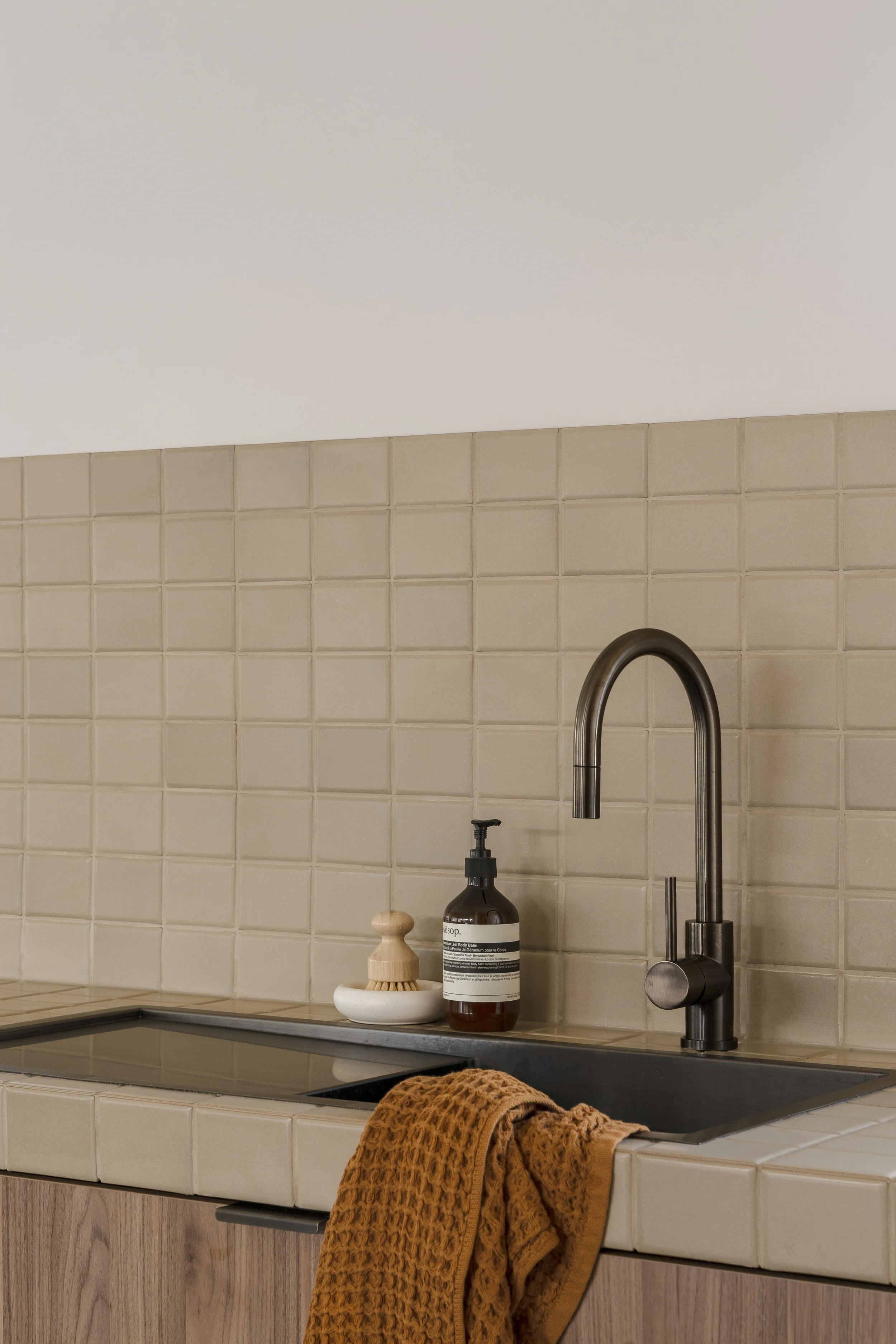 square mosaic tiled backsplach and vanity top industrial kitchen brushed gunmetal tapware