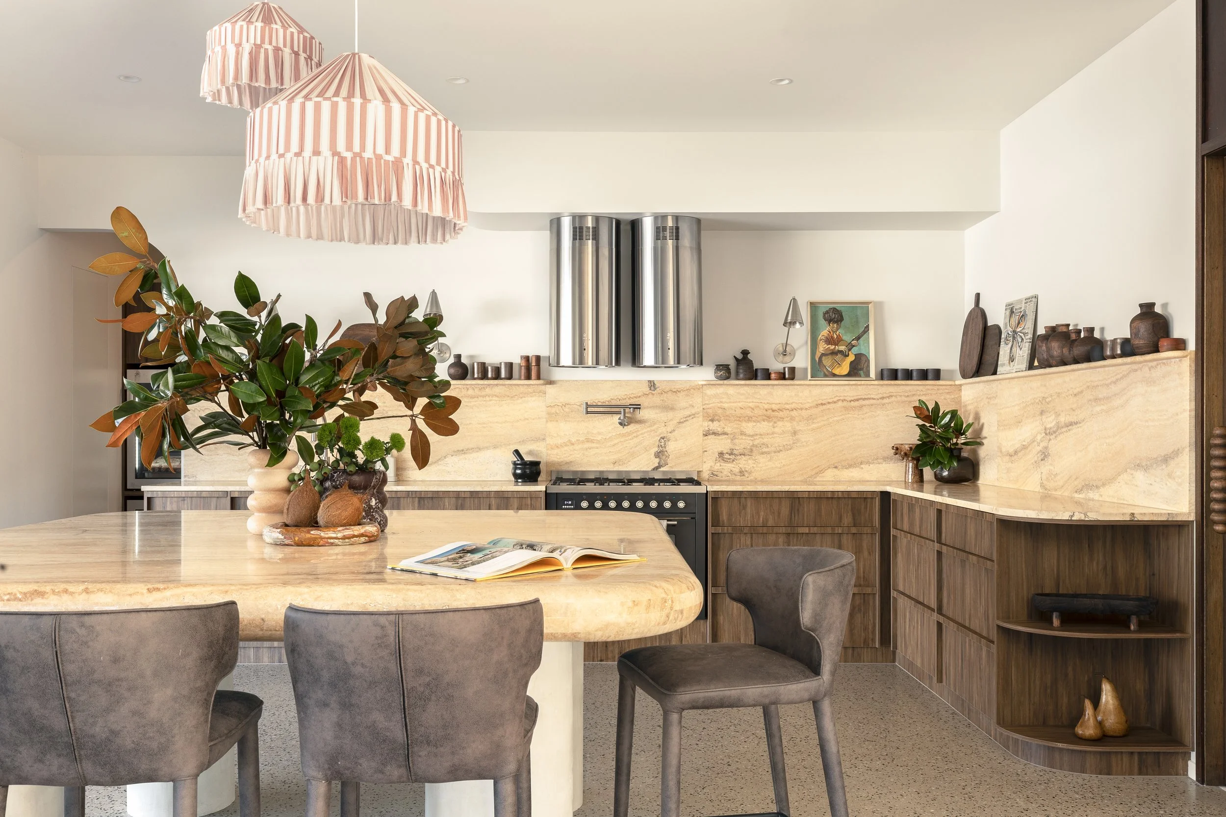 eclectic yellow marble kitchen with walnut cabinetry large dining table
