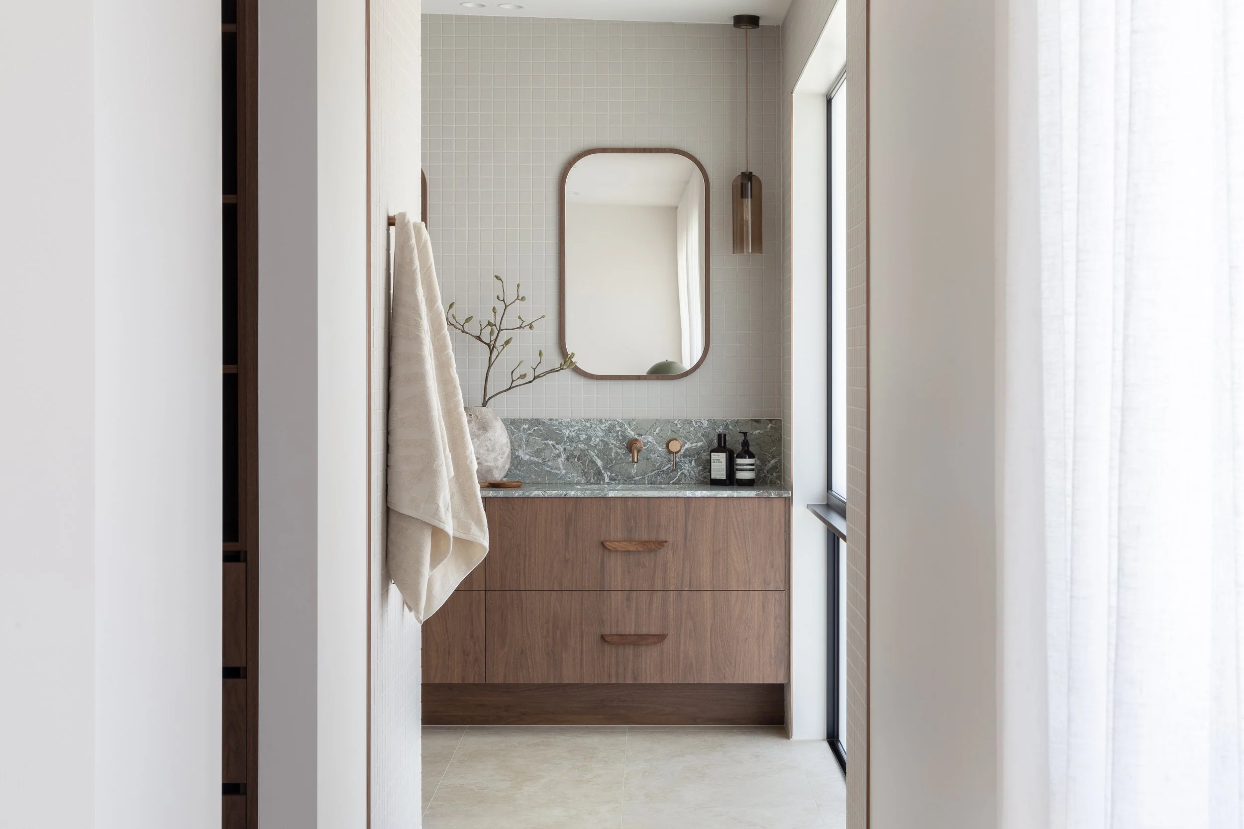 mid century modern coastal bathroom green marble walnut cabinetry