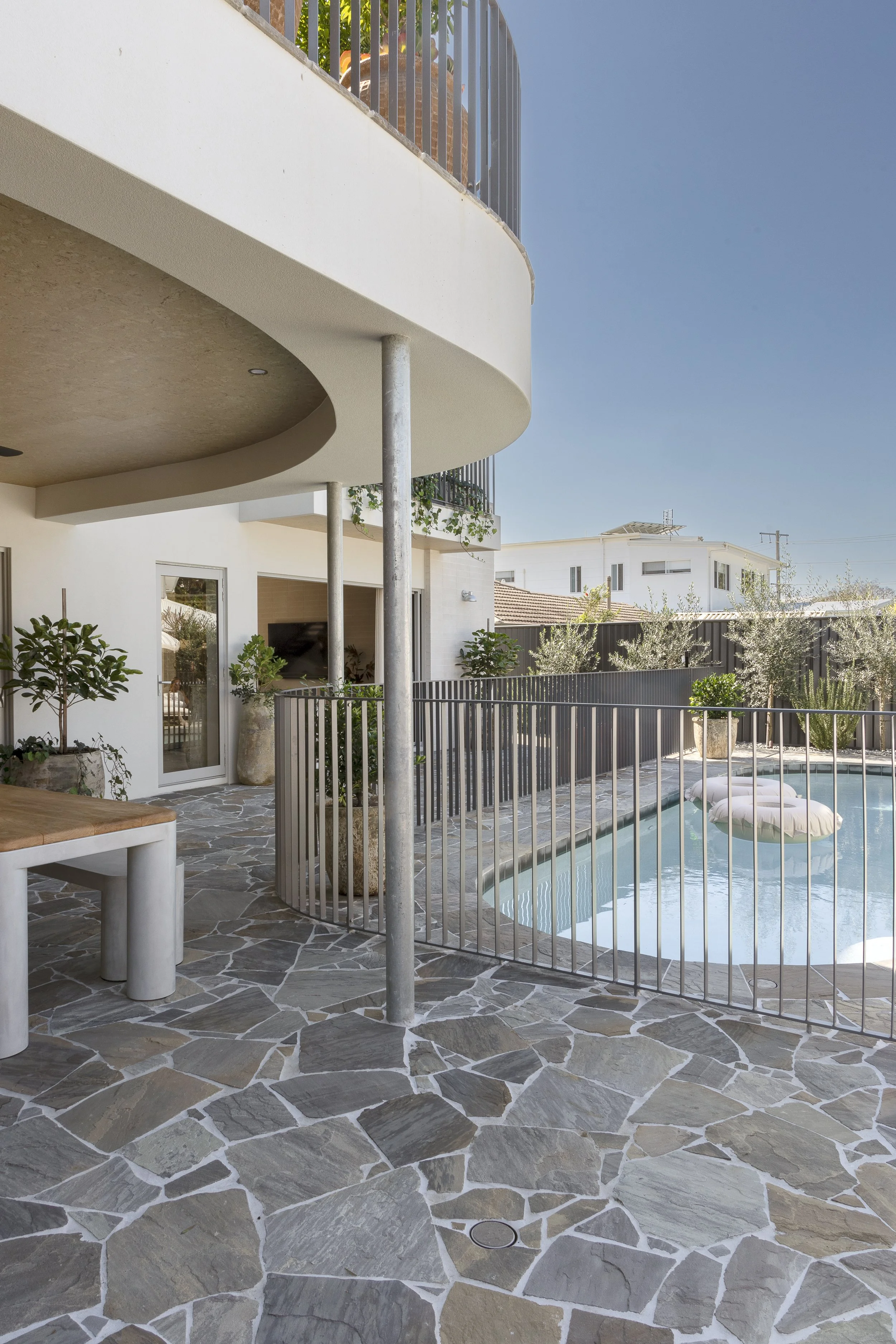 crazy pave outdoor area around oval pool