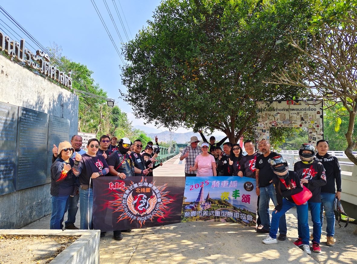 A group of tourist posing at the memorial bridge in Pai, Mae Hong Sorn