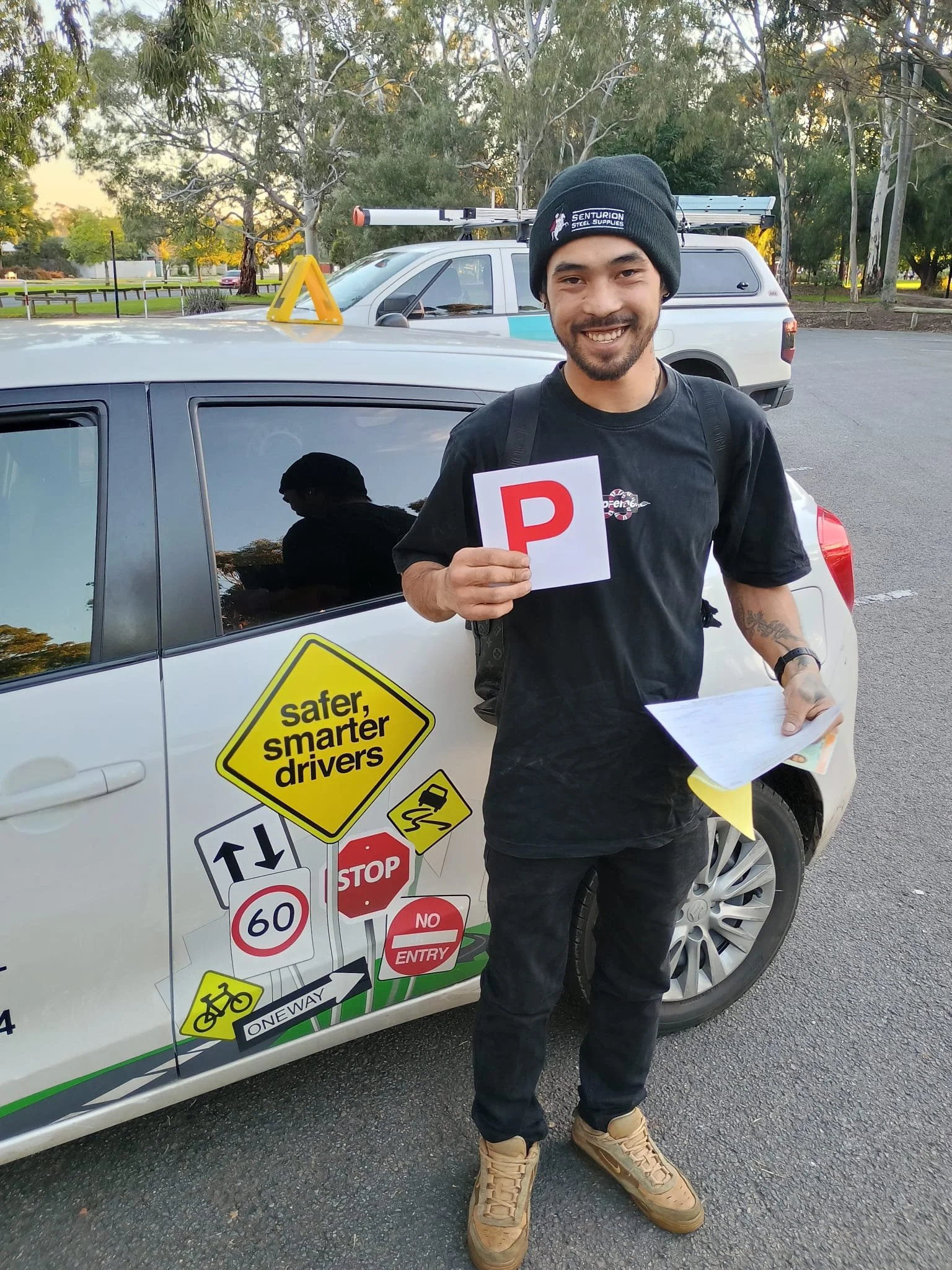 A student got his P plates after training at Satisfy Driving School