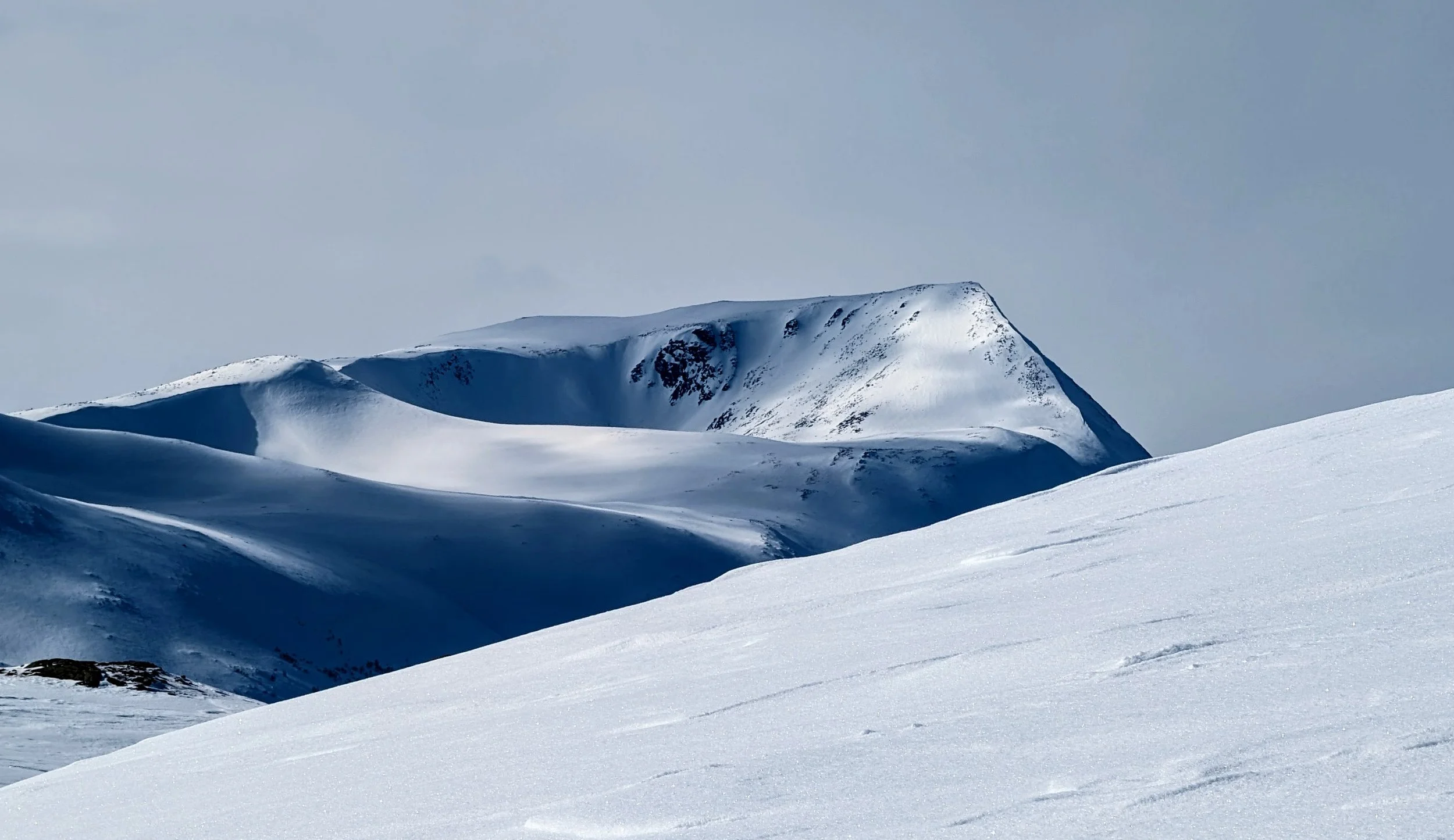 Snow-covered mountains under clear sky