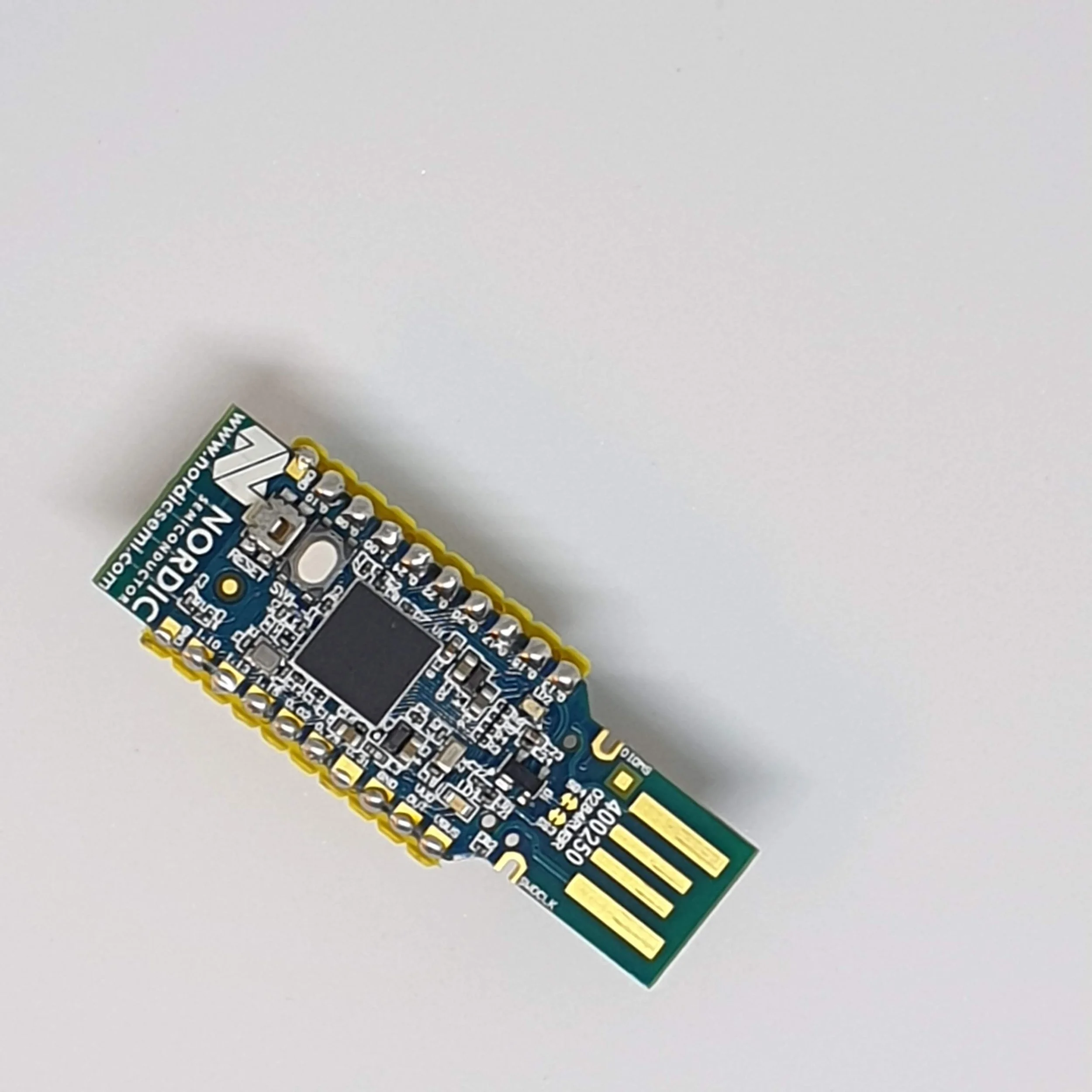 Nordic Semiconductor USB dongle on a light gray background