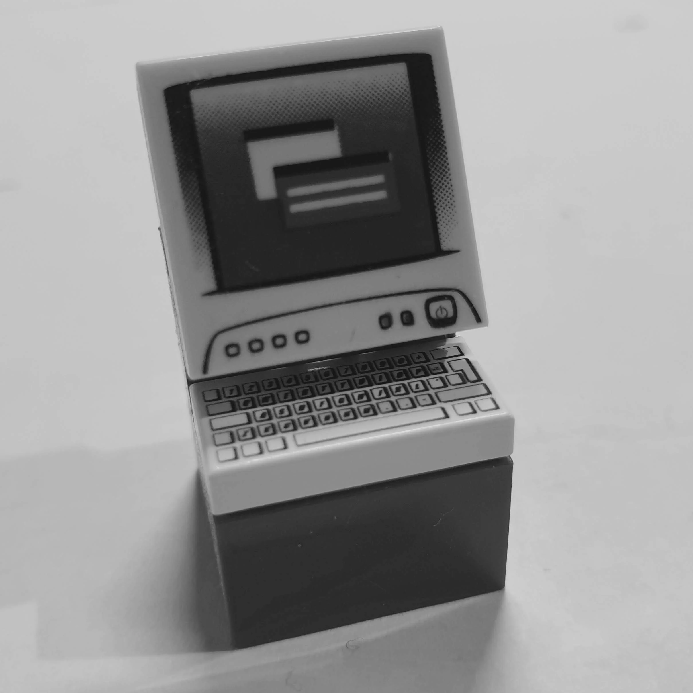 LEGO-style toy computer model, monochrome