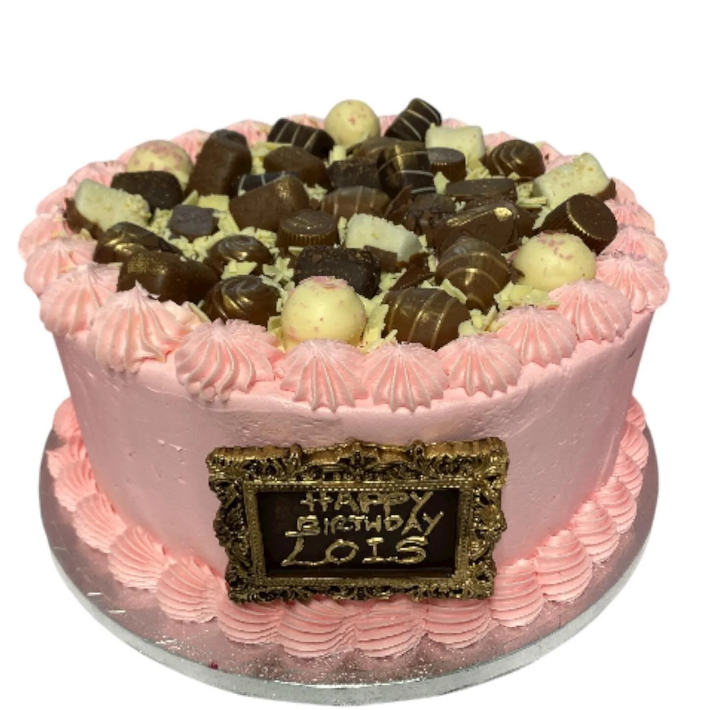 Chocolate cake with pink frosting and Thorntons chocolates.